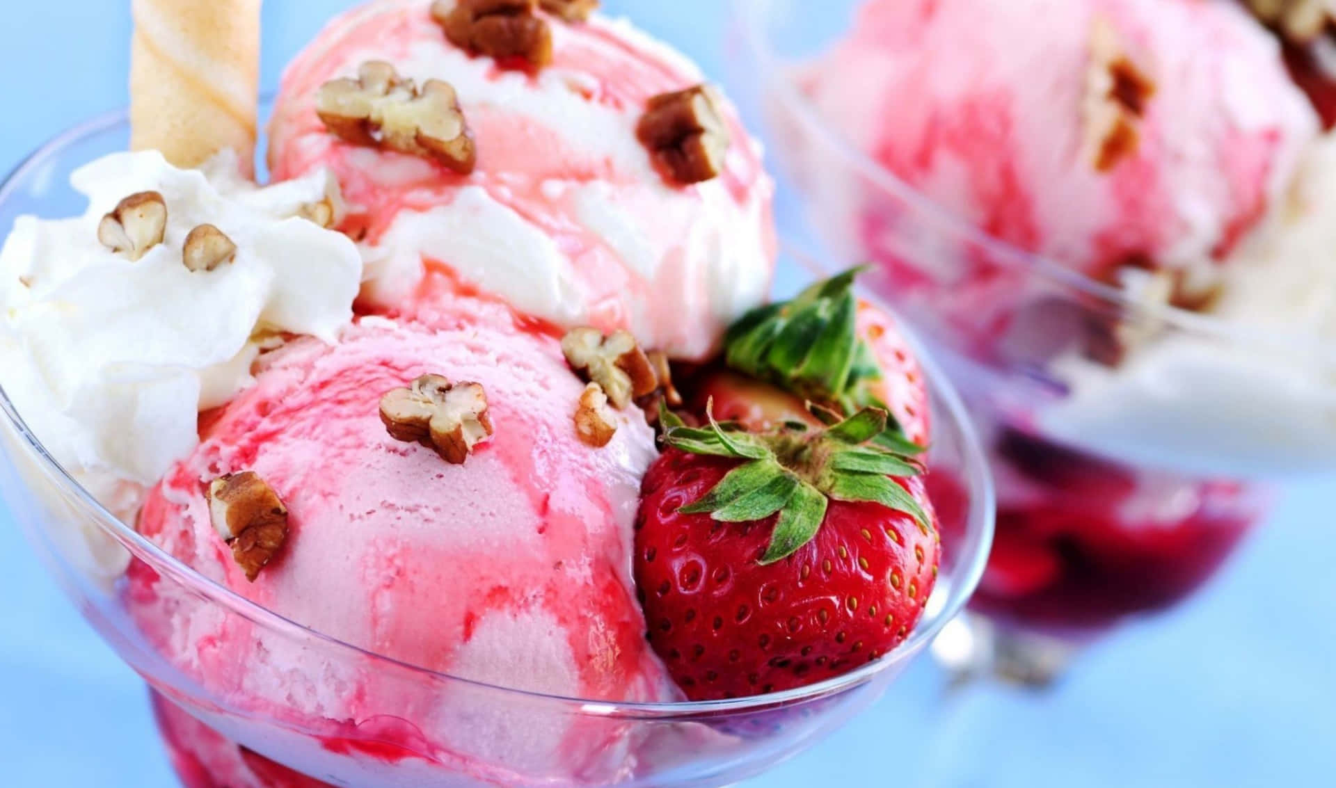 A Glass Of Ice Cream With Strawberries And Nuts