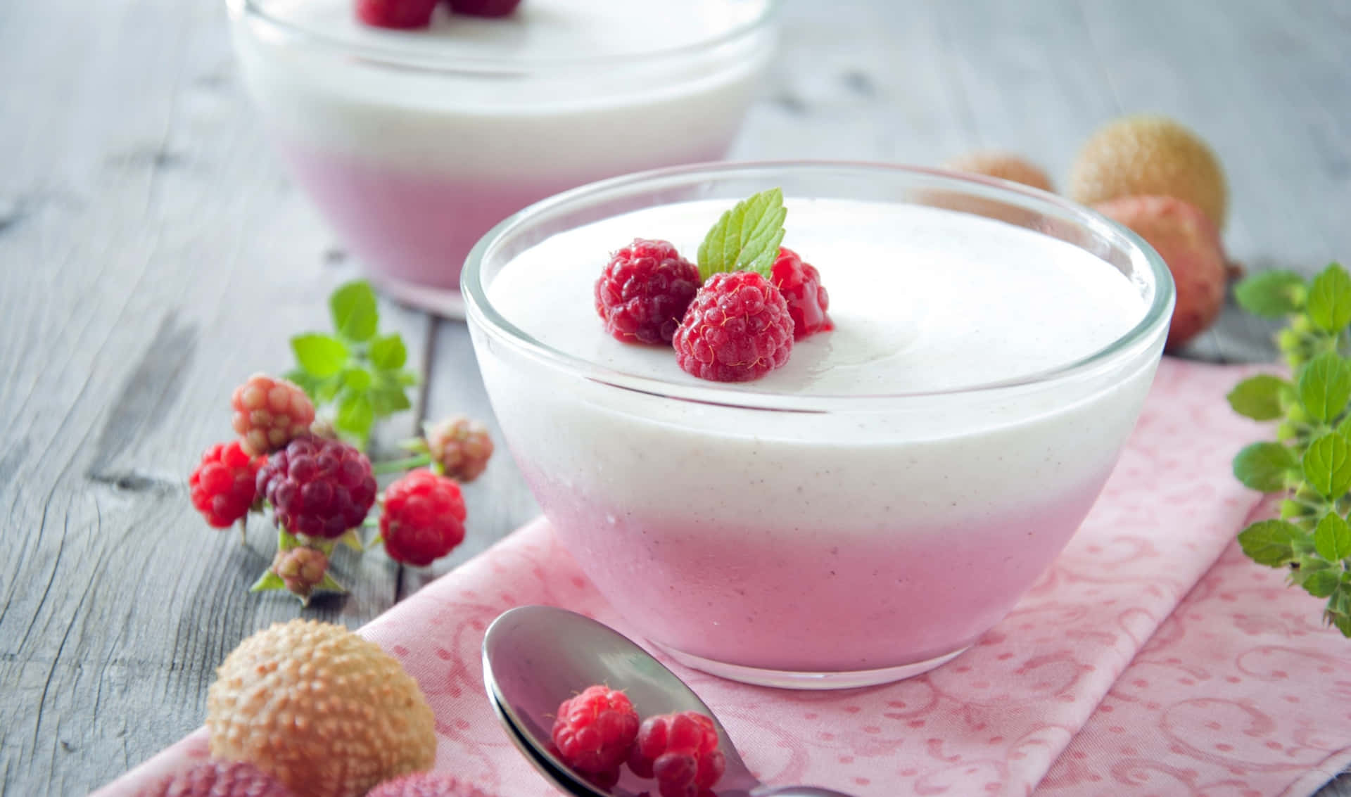 Two Cups Of Yogurt With Raspberries And Mint