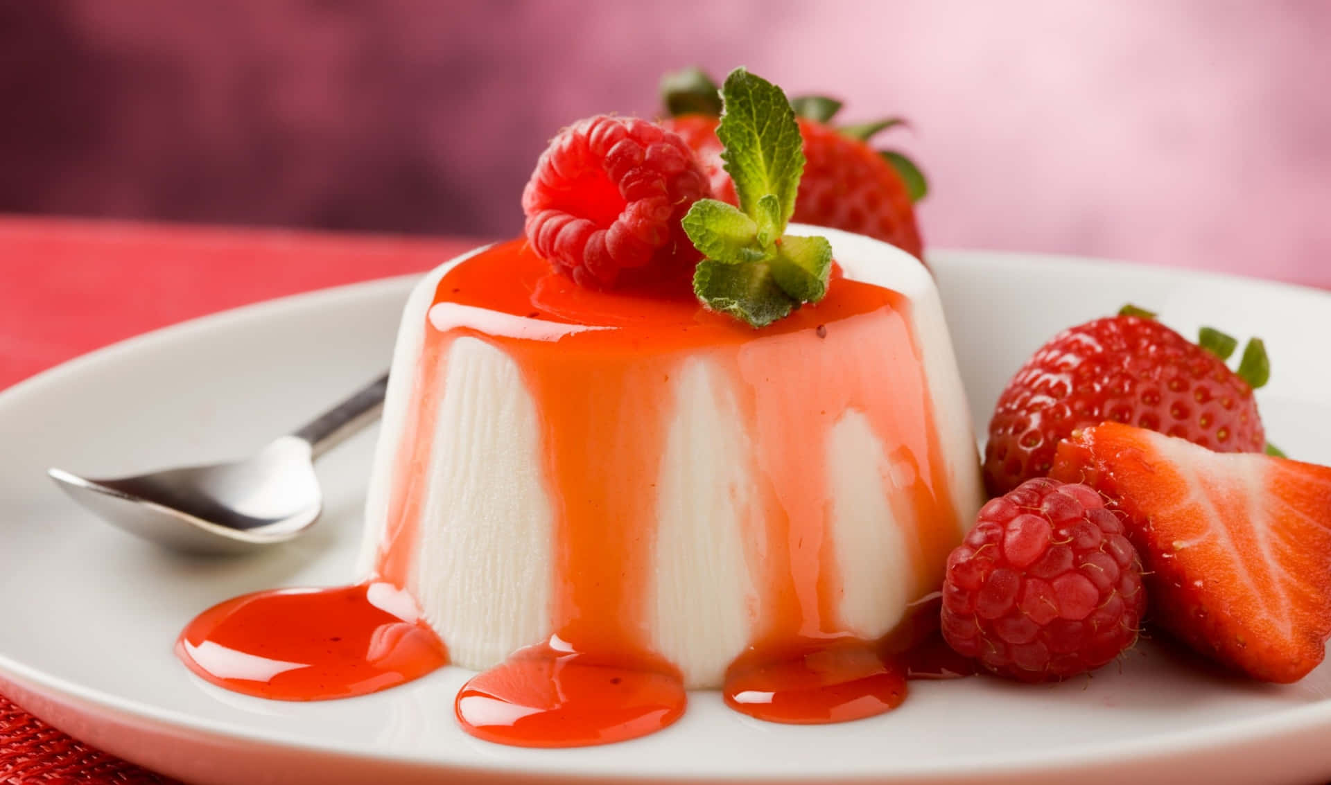 A Plate With A Dessert With Strawberries And Sauce