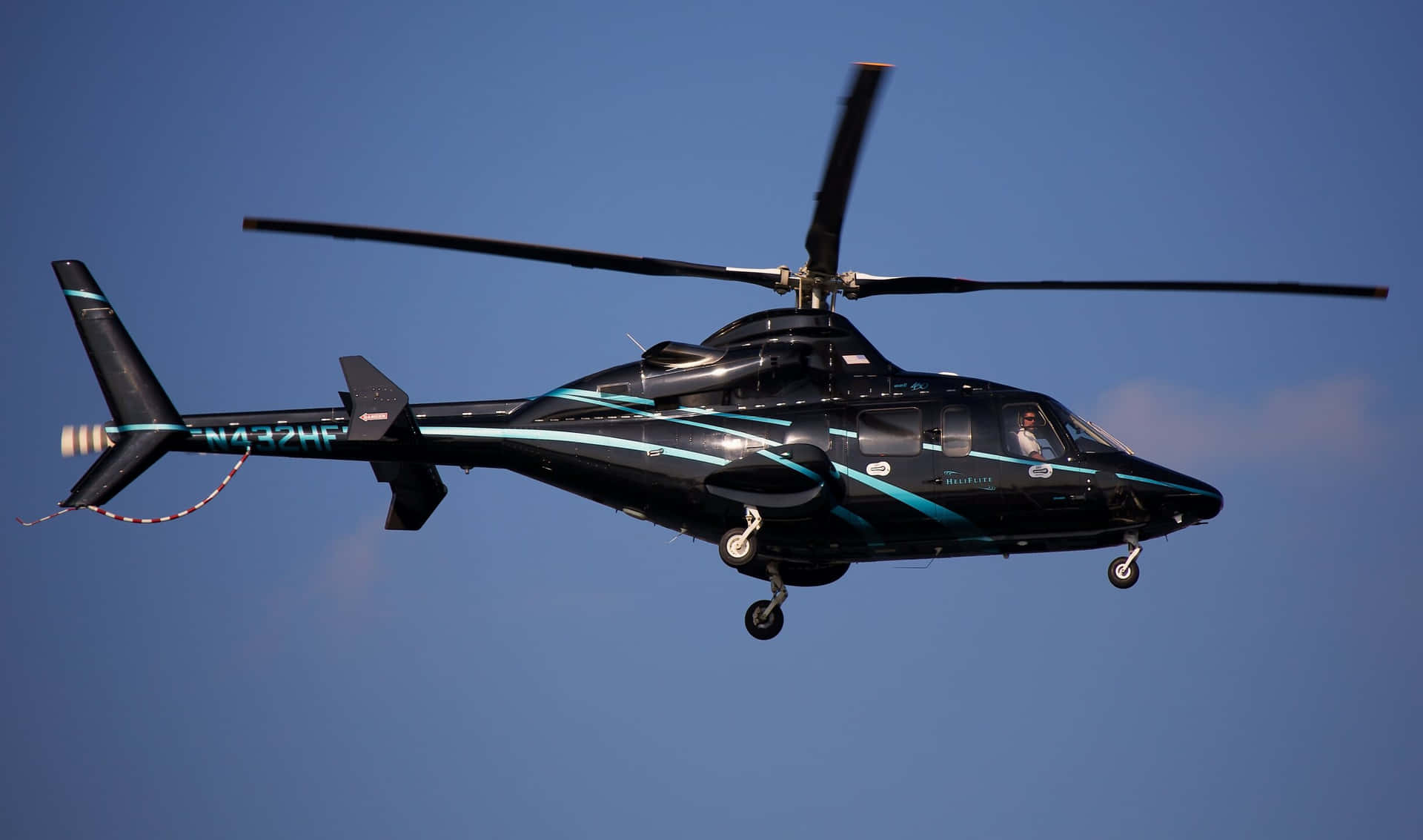 Doshelicópteros En Un Cielo Gris Con Un Mar Azul Vibrante En El Fondo.