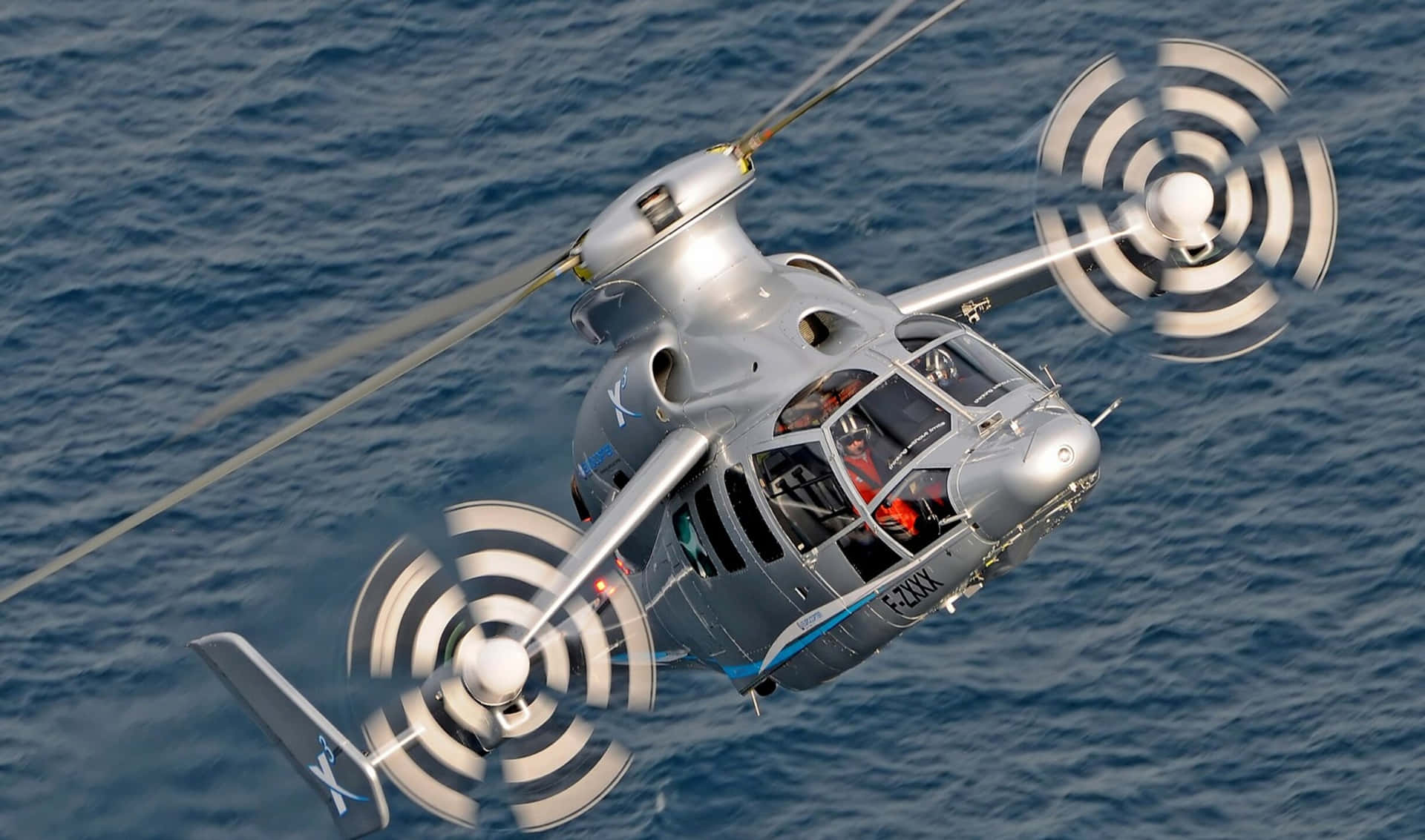 Fotografíade Alta Resolución De Un Helicóptero Azul Y Amarillo Inclinándose Contra Un Cielo Azul Claro.