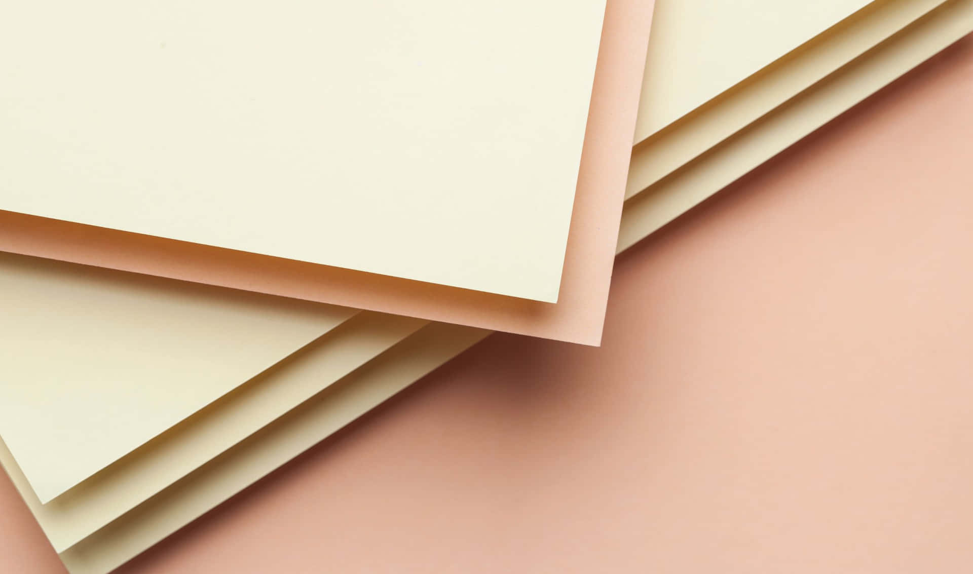 A Stack Of Paper On A Pink Background