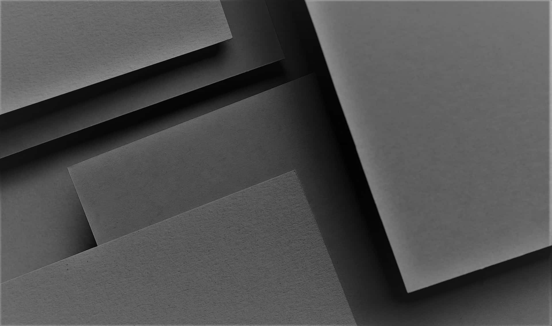 Aclose-up Of A Gray Colored Paper: Un Primer Plano De Un Papel De Color Gris.