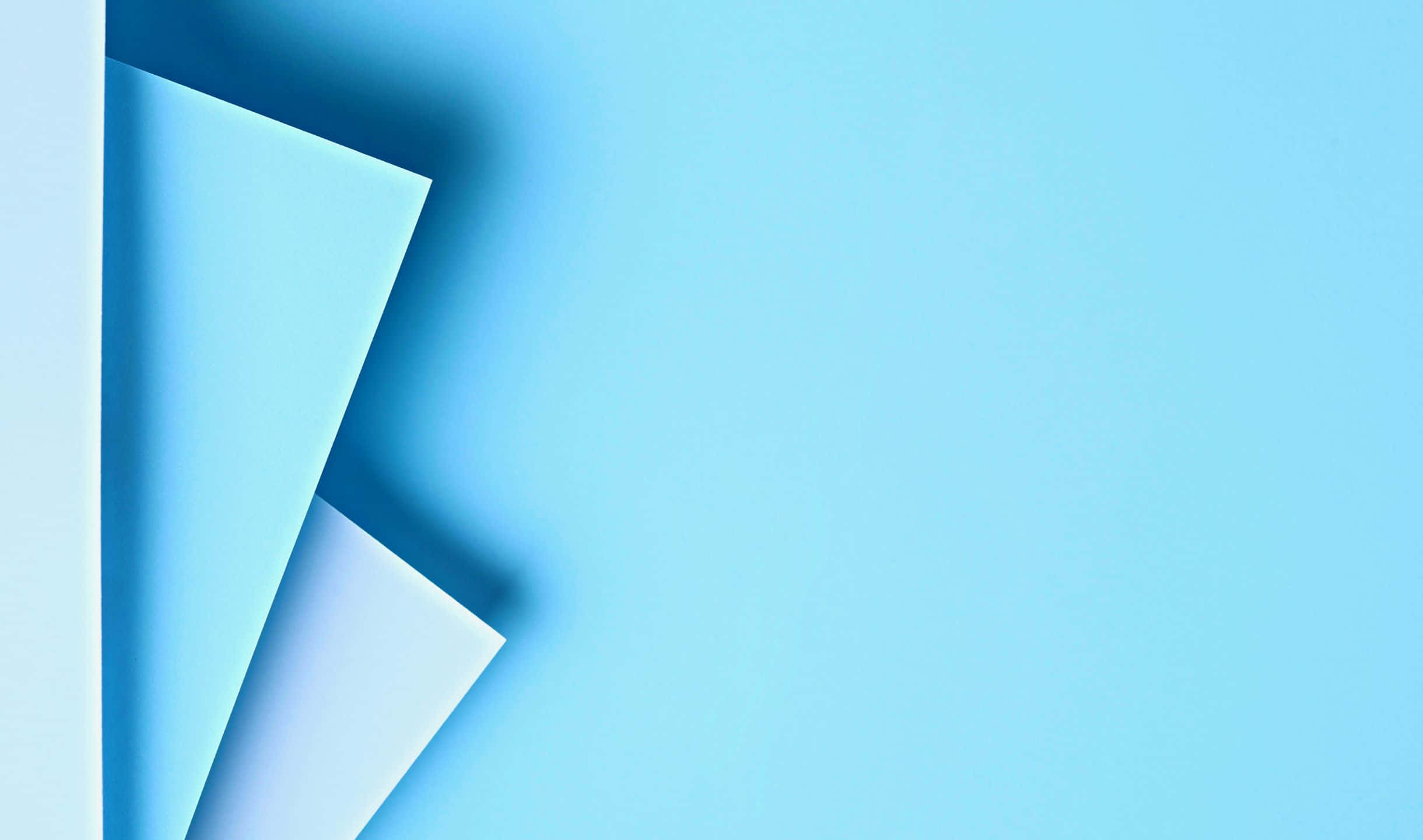 A Blue Paper Folded In Half On A Blue Background
