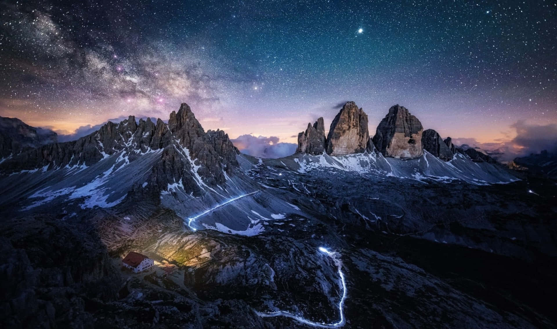 a mountain with a cabin under the stars