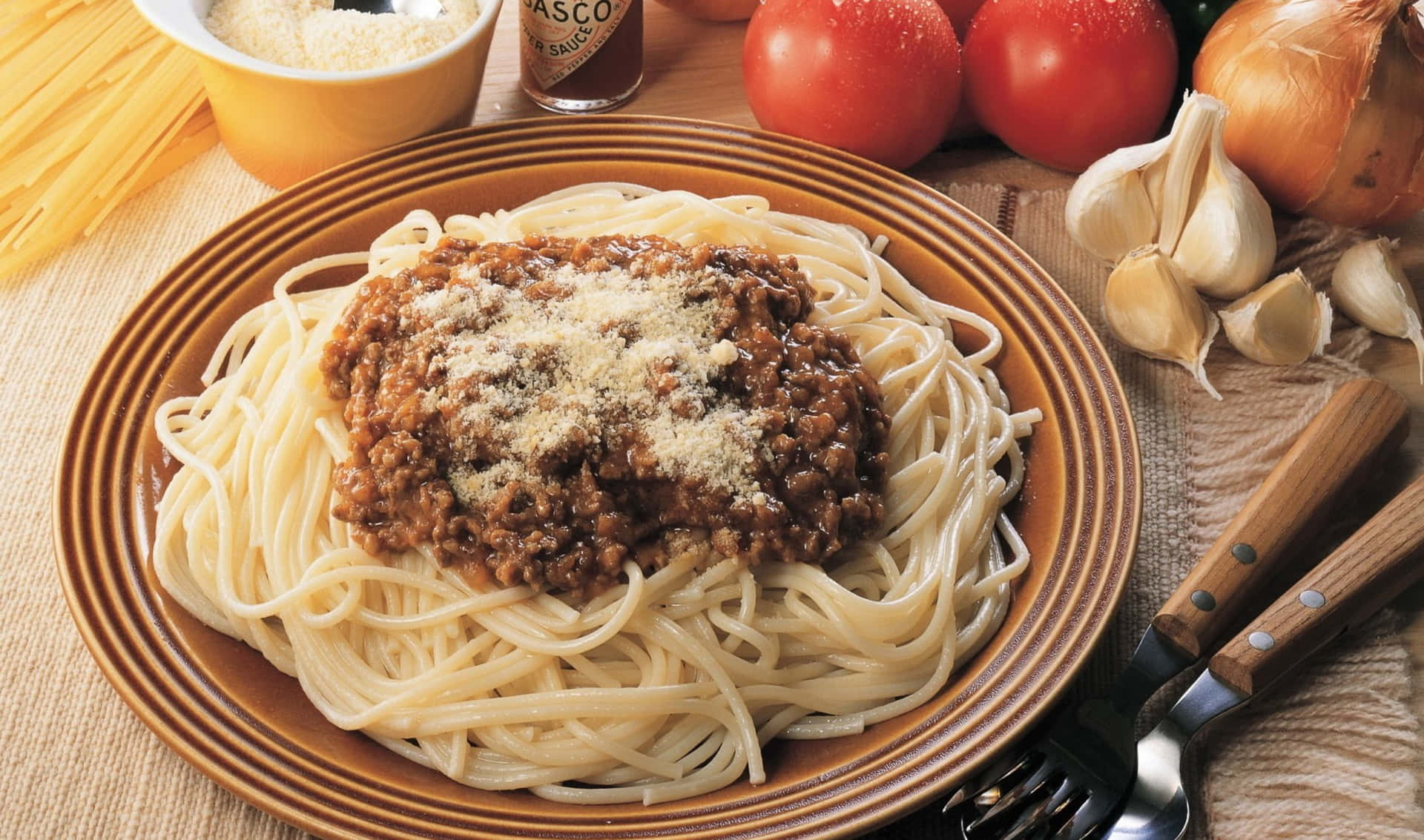 A Plate Of Spaghetti With Meat Sauce And Vegetables