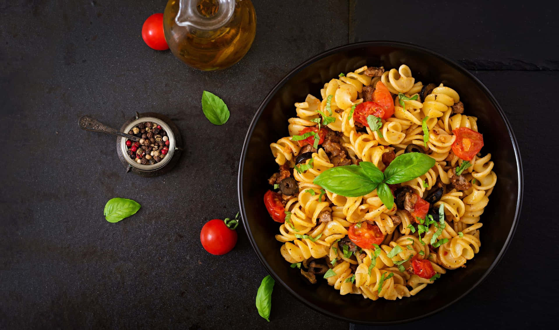 Pasta With Tomatoes And Herbs In A Black Bowl