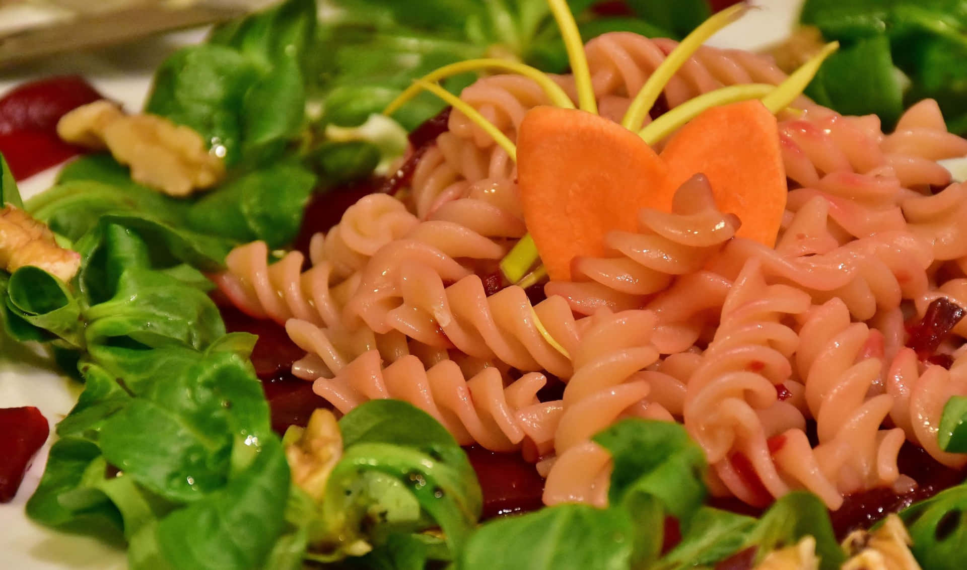 A Plate Of Pasta With Carrots, Walnuts And Cranberries