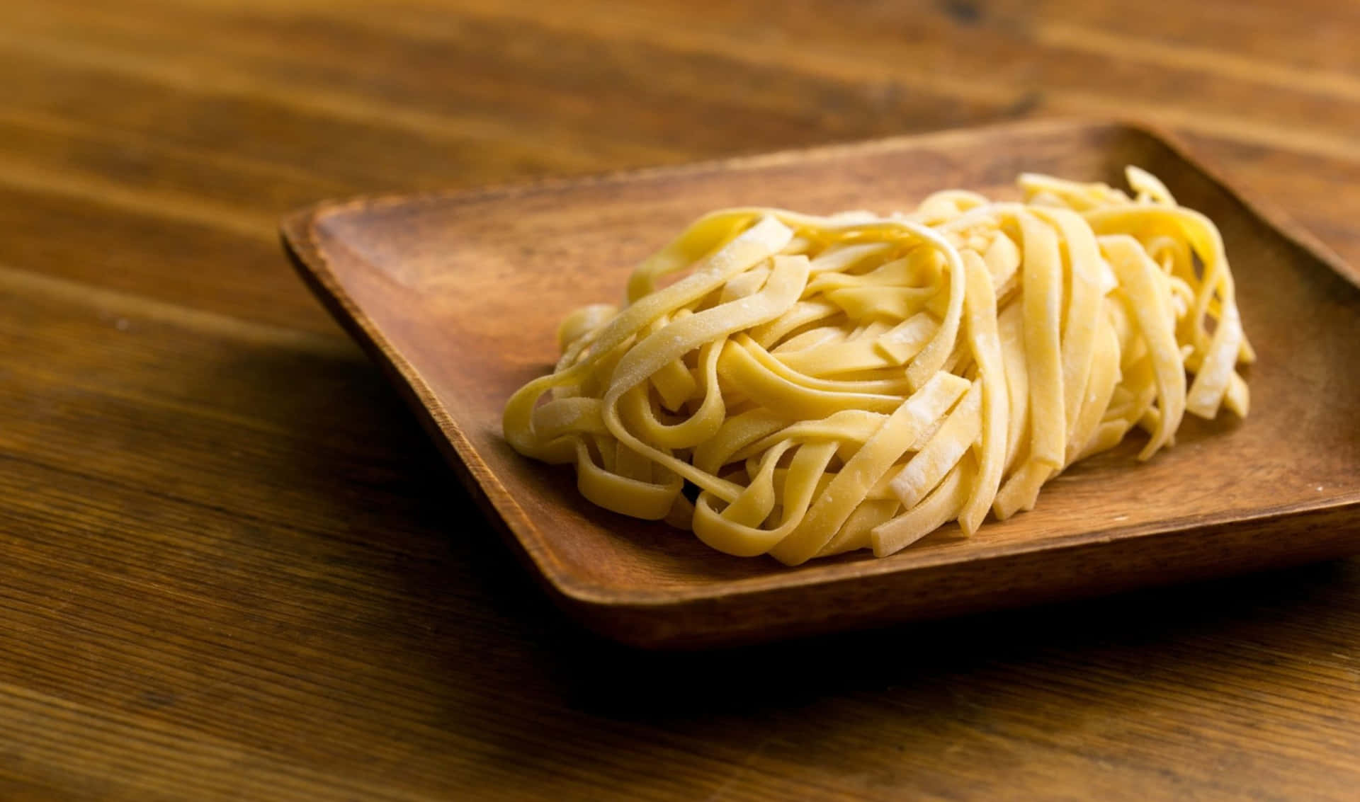 A Plate Of Pasta On A Wooden Table