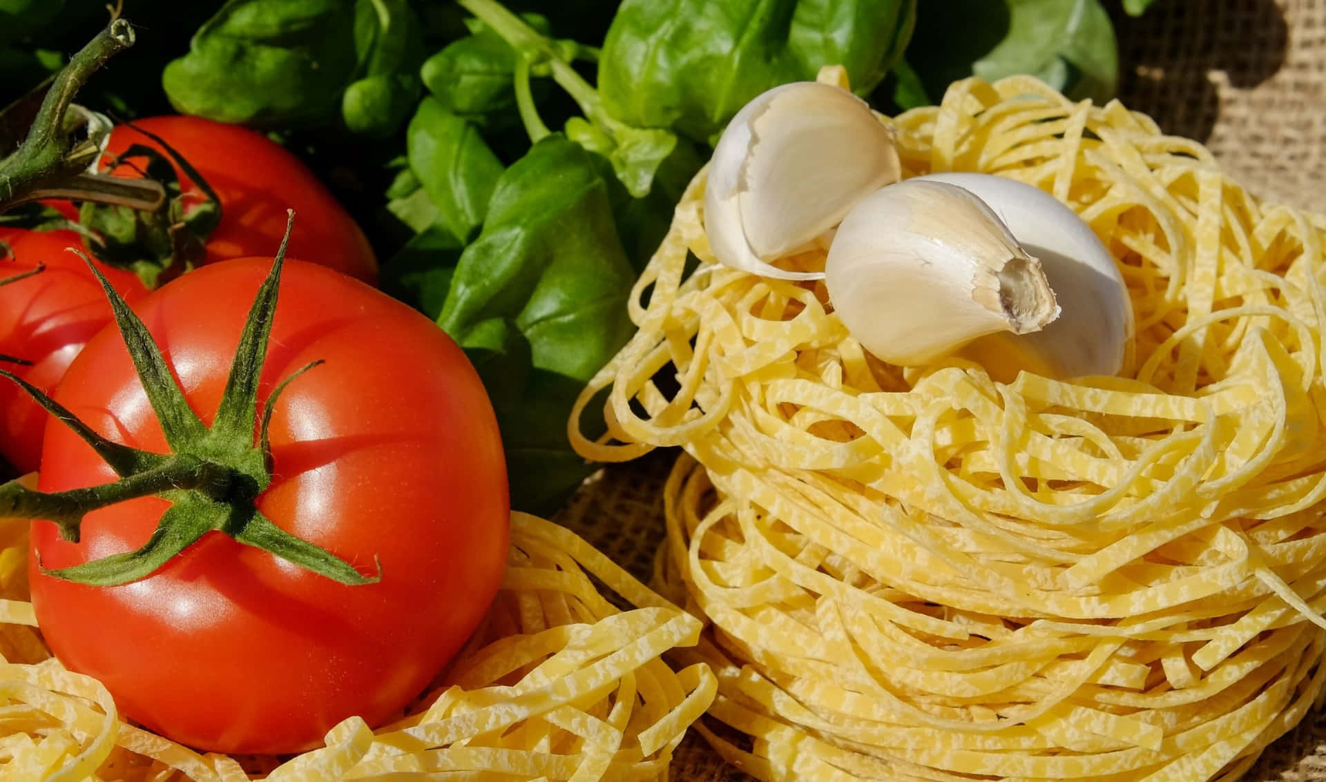 A Bowl Of Pasta With Tomatoes, Garlic And Basil