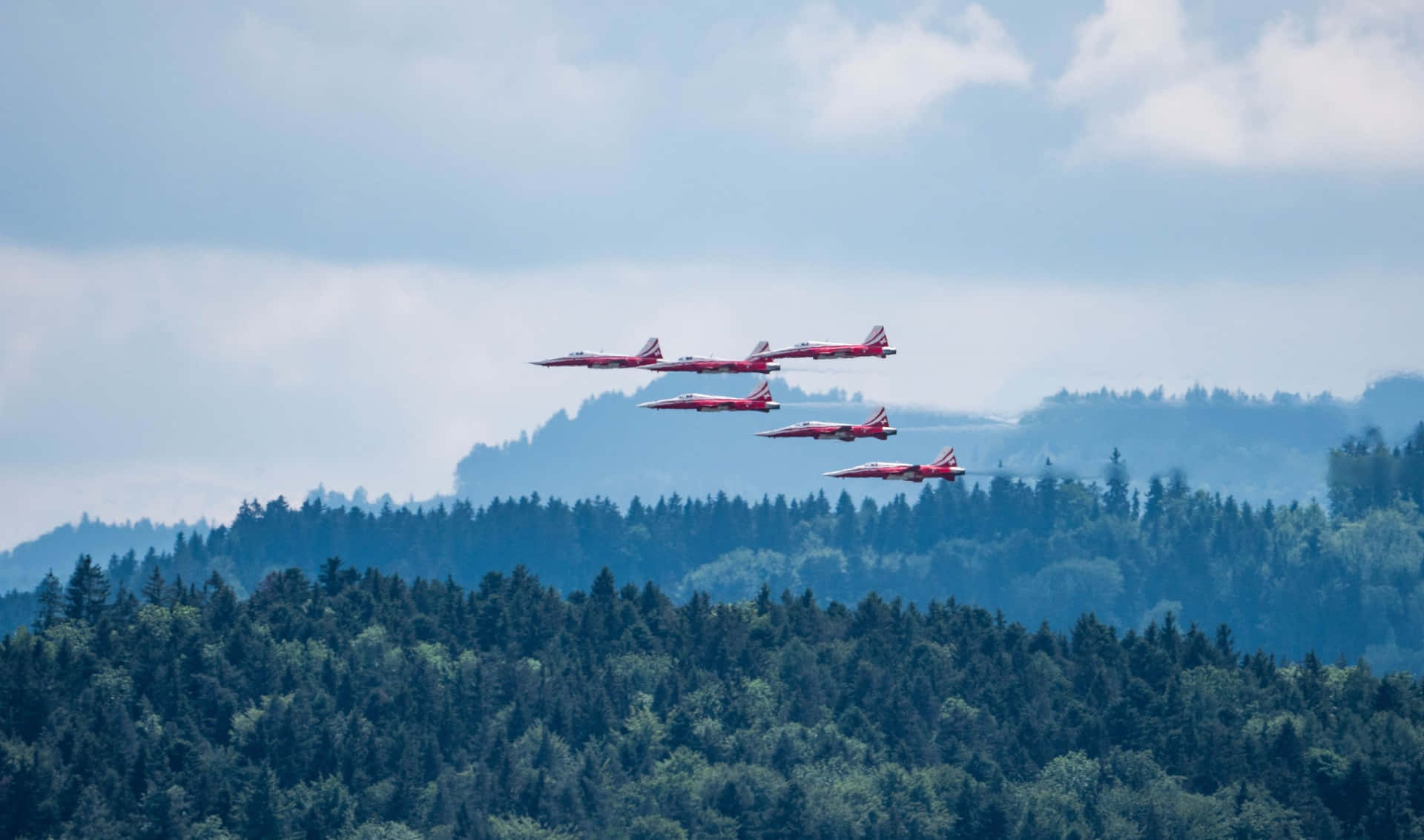 Red Arrows Flying Over A Forest