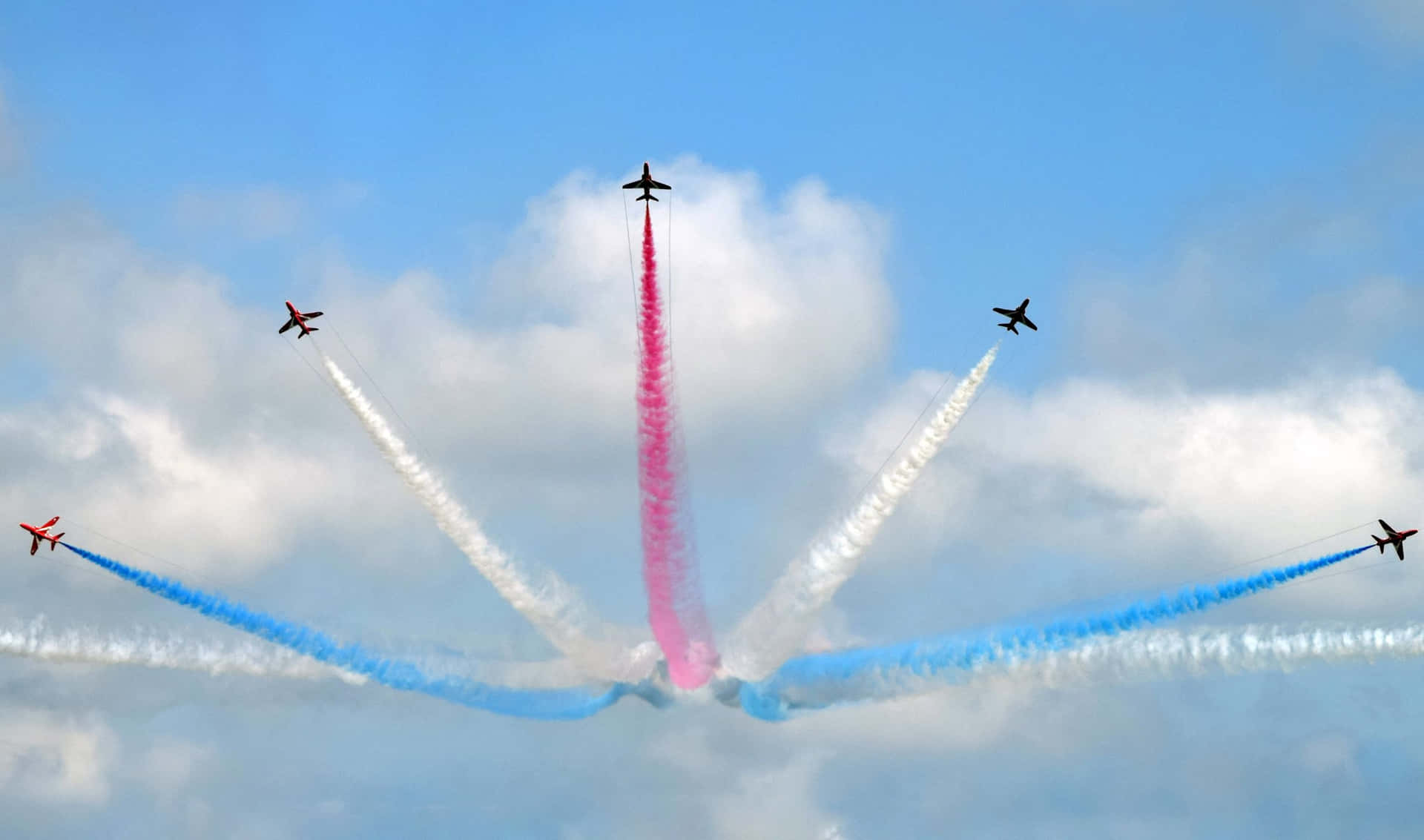 Ungrupo De Aviones Volando En Formación Con Humo Rojo, Azul Y Blanco.