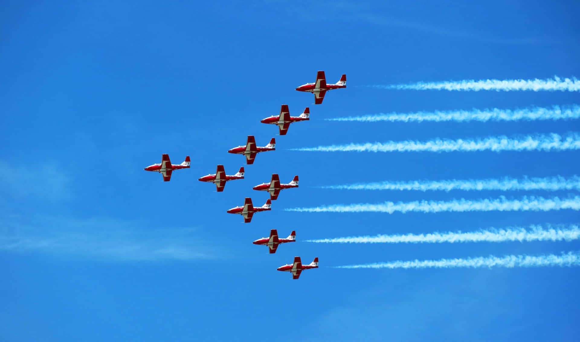 A Group Of Planes Flying In Formation