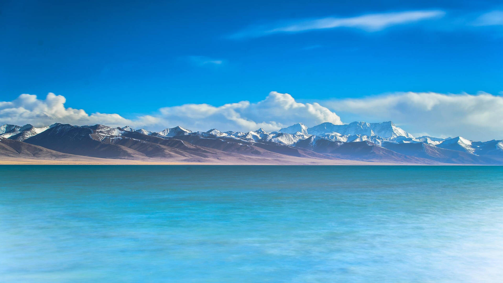 2560 X 1440 Mountain Range By The Sea Picture