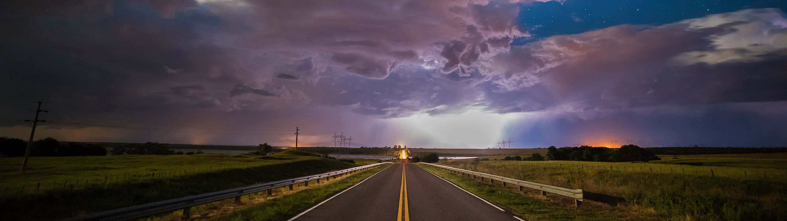 Lightning Over A Road With A Cloudy Sky Wallpaper