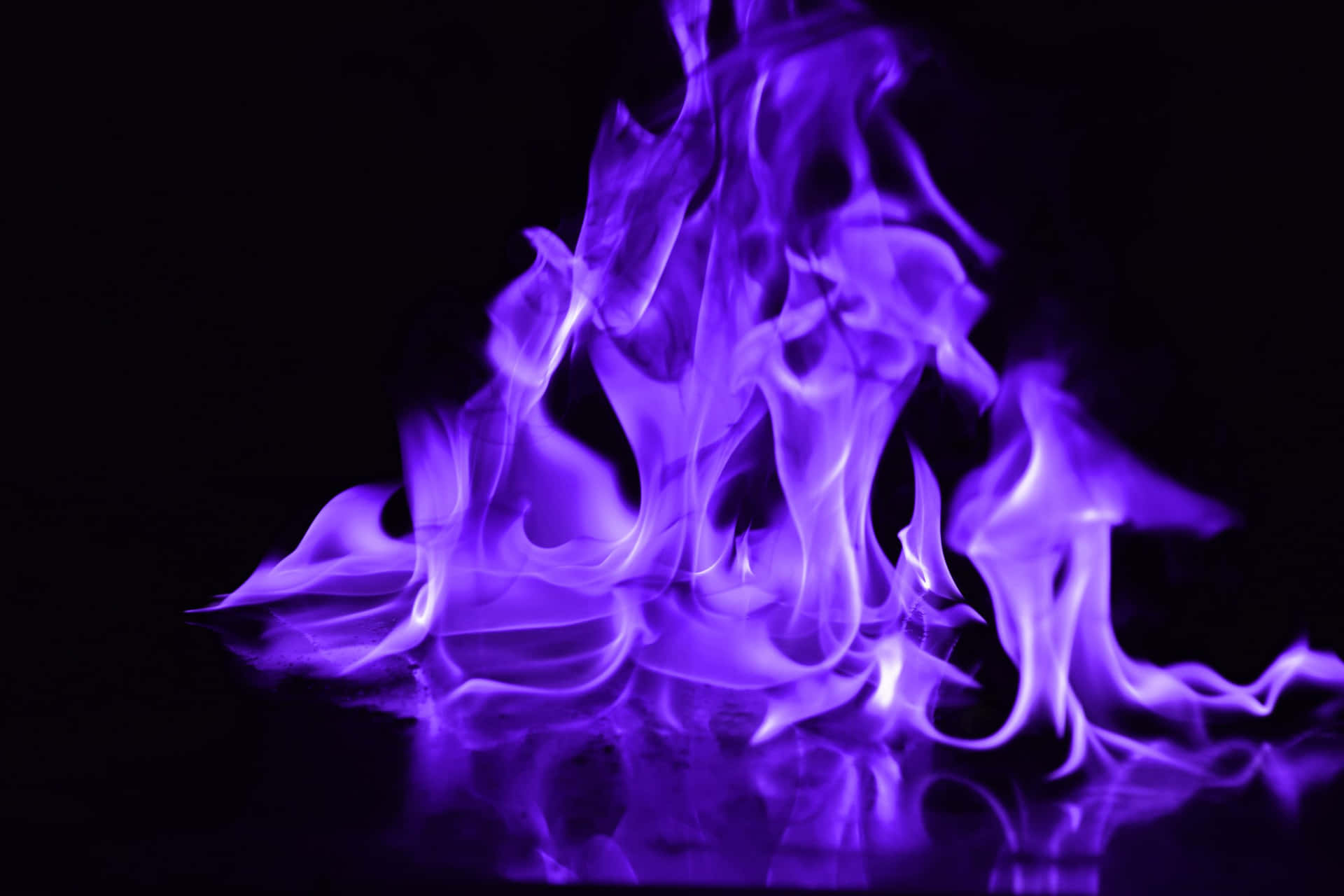 Purple Flames On A Black Background Wallpaper