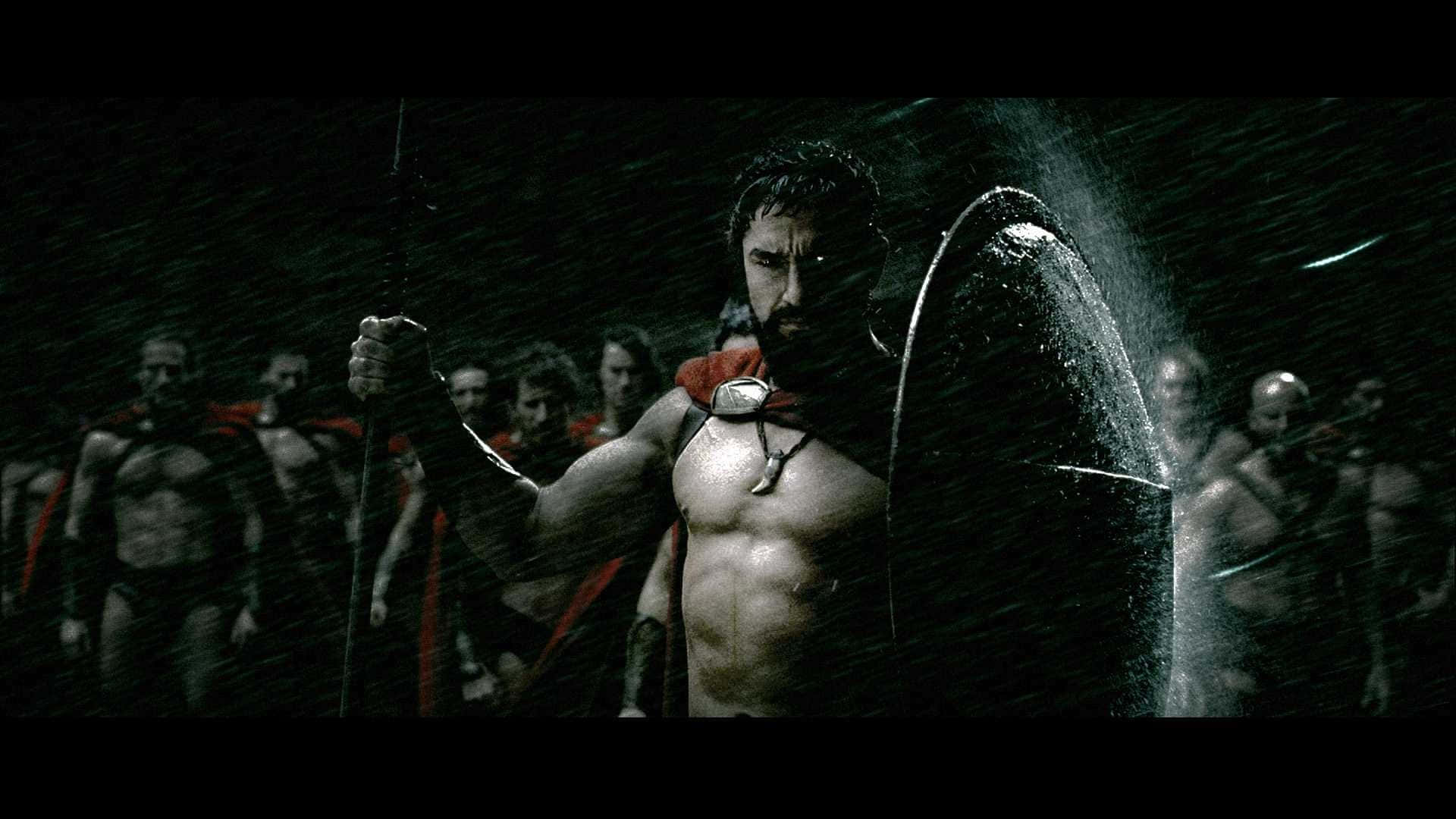 A Man In A Spartan Outfit Standing In The Rain Wallpaper