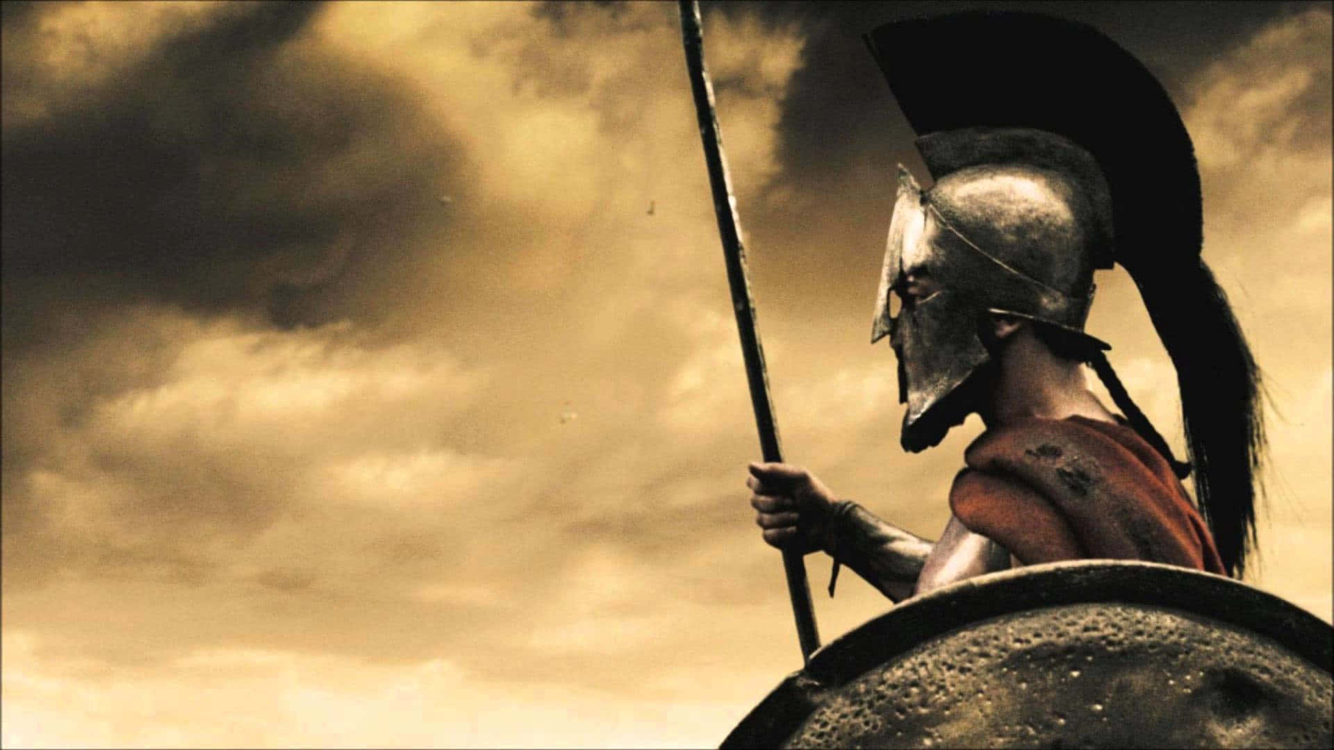 A Spartan Soldier Is Holding A Shield And Spear Wallpaper