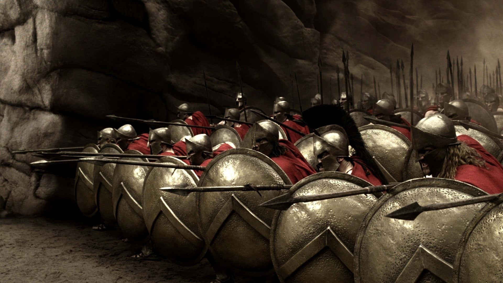 A Group Of Spartans Are Standing In A Cave Wallpaper