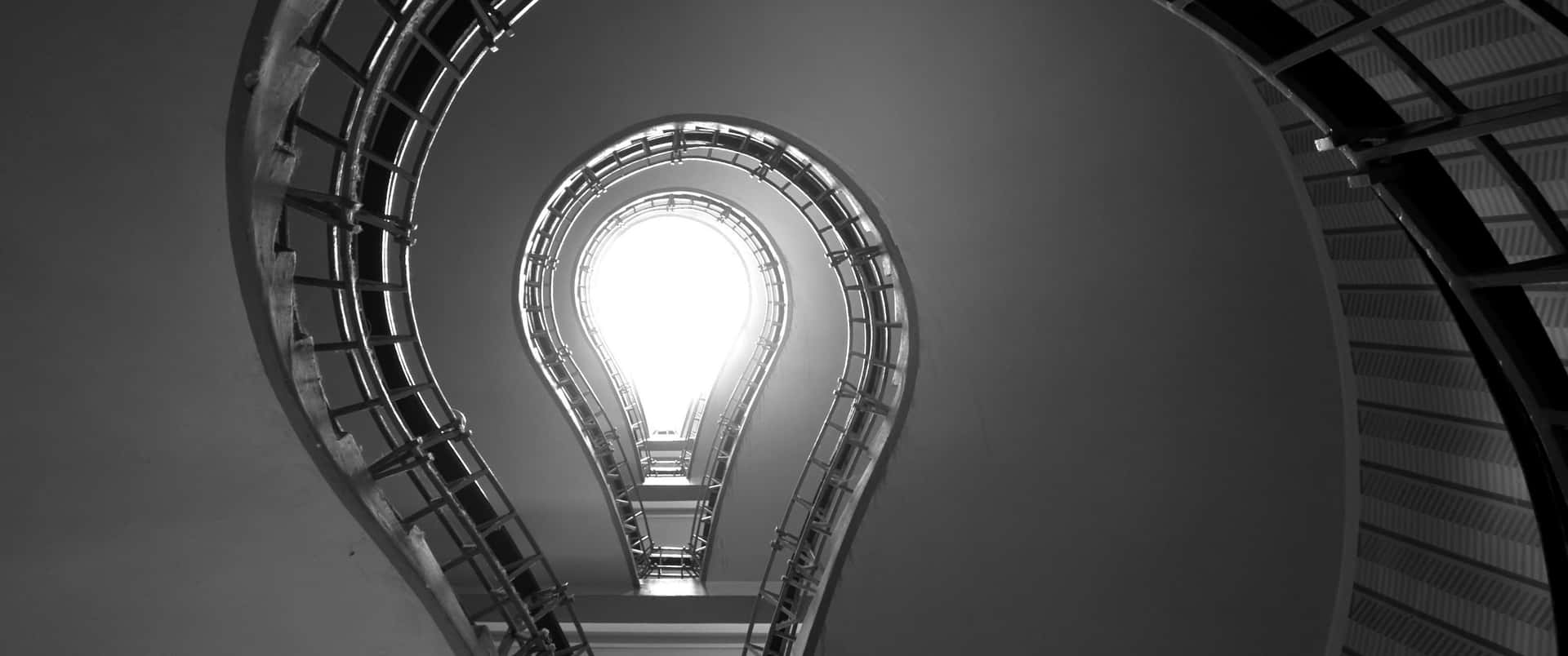 A Black And White Photo Of A Spiral Staircase
