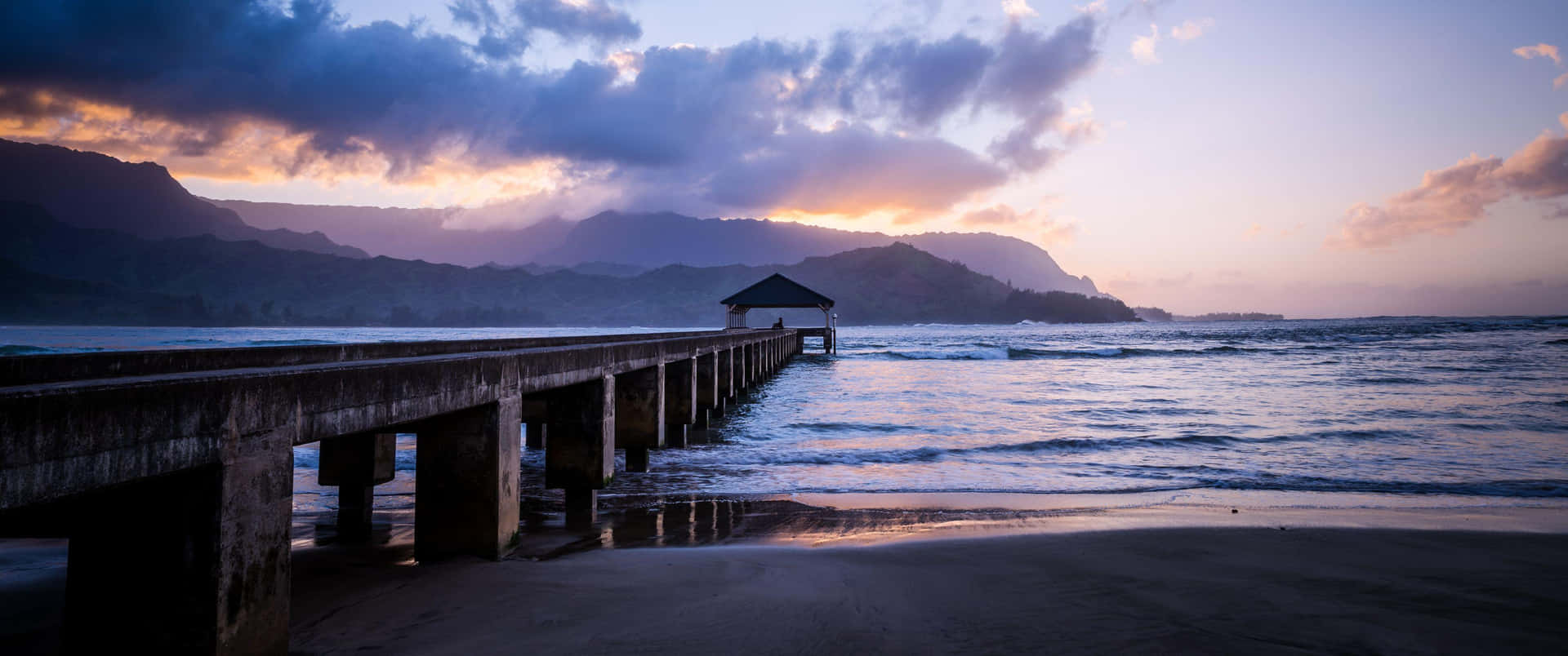 A Pier With A Sunset View Over The Ocean Wallpaper