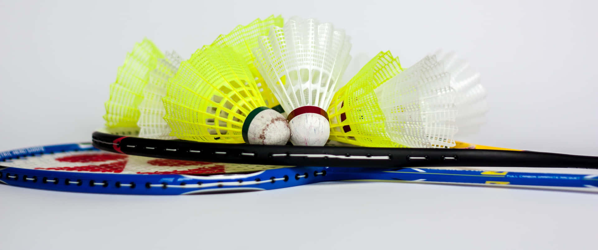 Badminton Rackets And Balls On A White Background