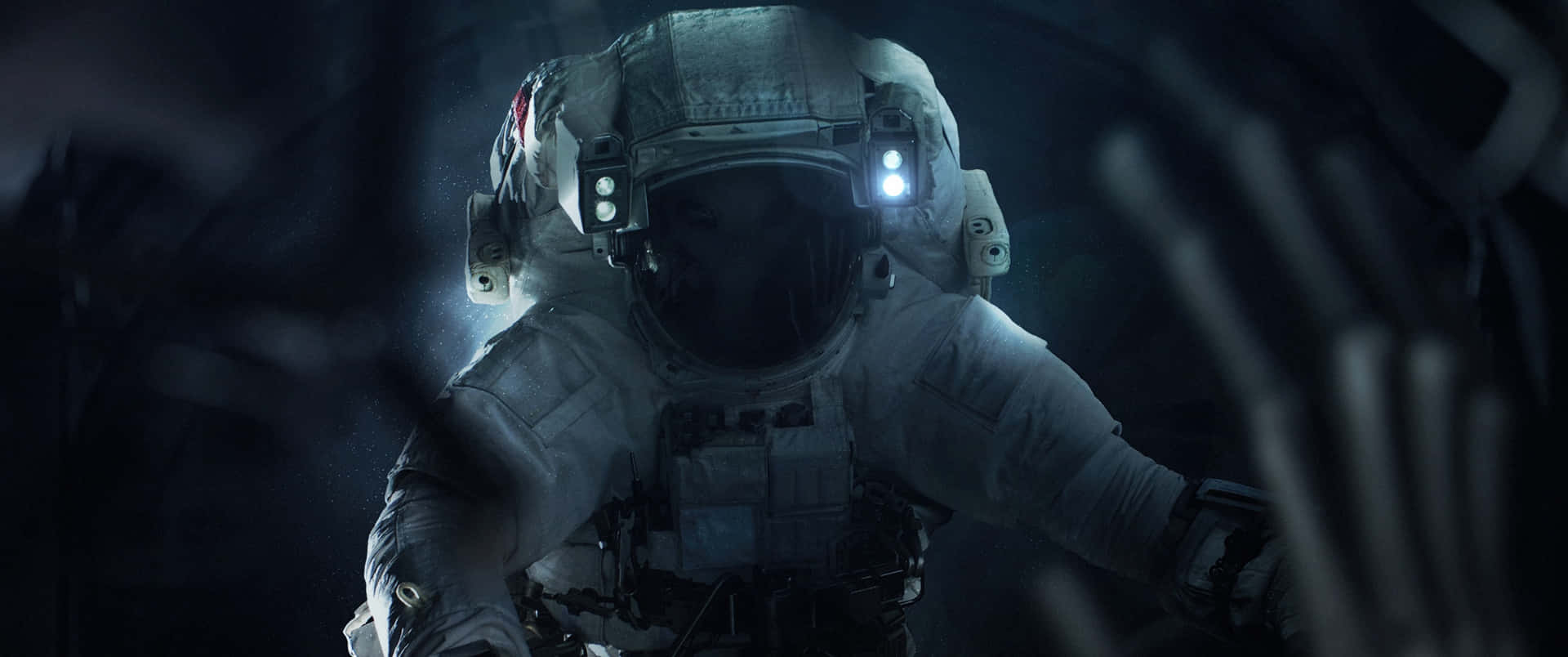 a man in spacesuit is walking through a dark tunnel