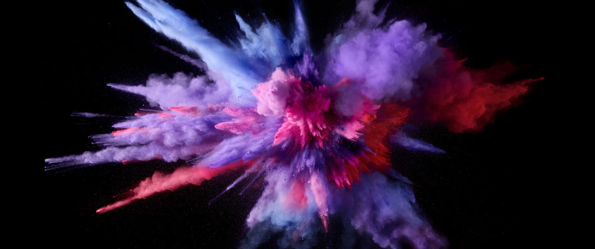 a colorful powder explosion on a black background