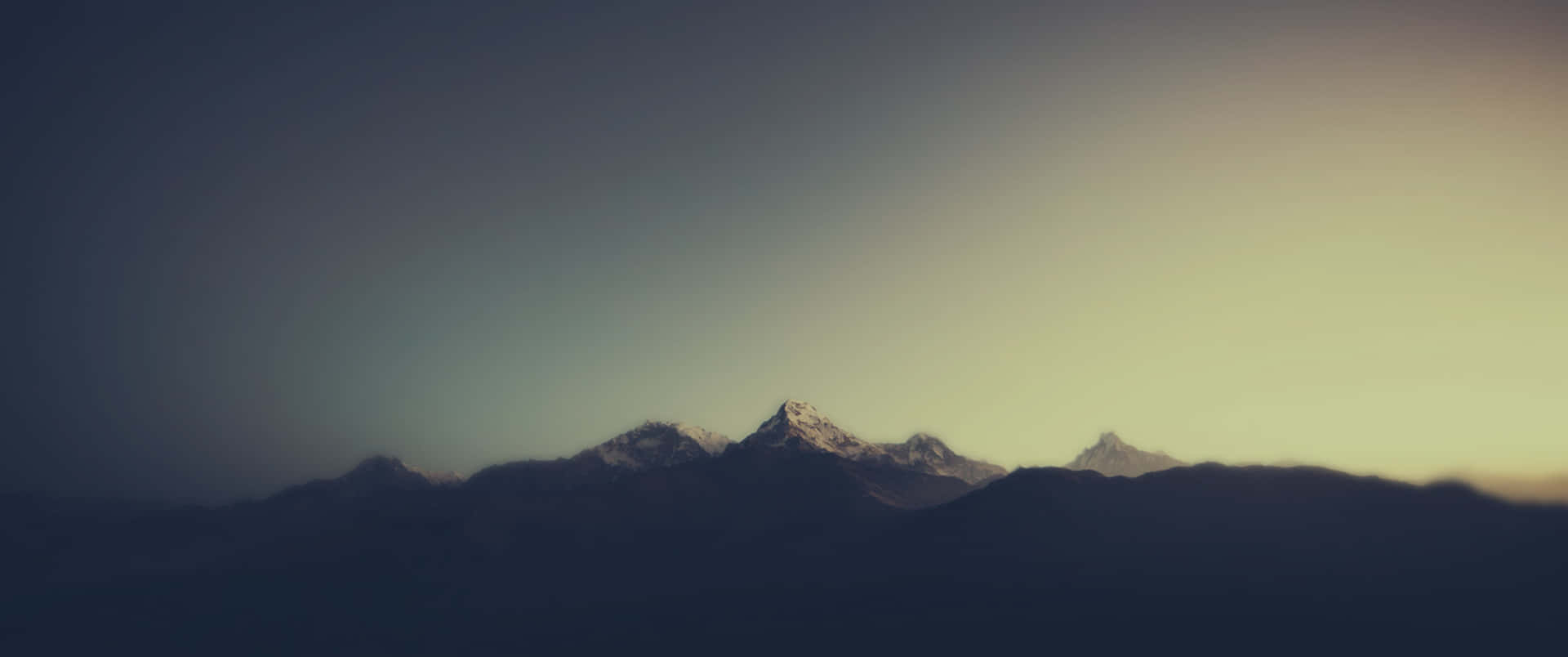 a mountain range with a sunset behind it