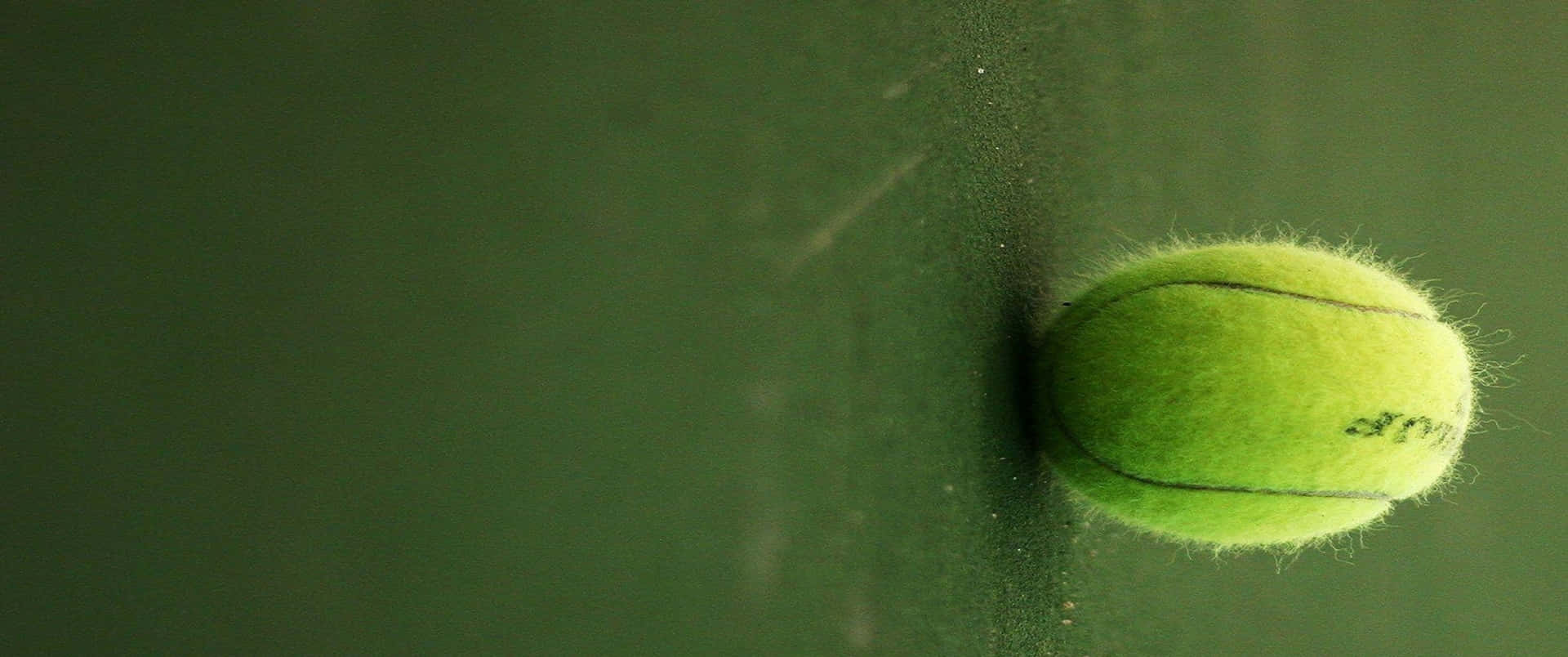 A Tennis Ball Is On A Wall