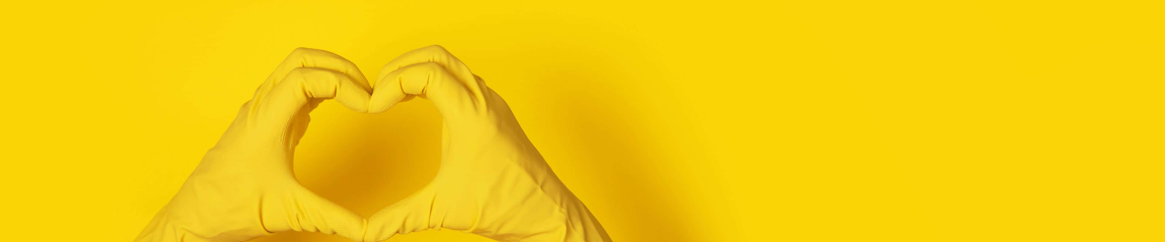 A Pair Of Yellow Gloves On A Yellow Background Wallpaper