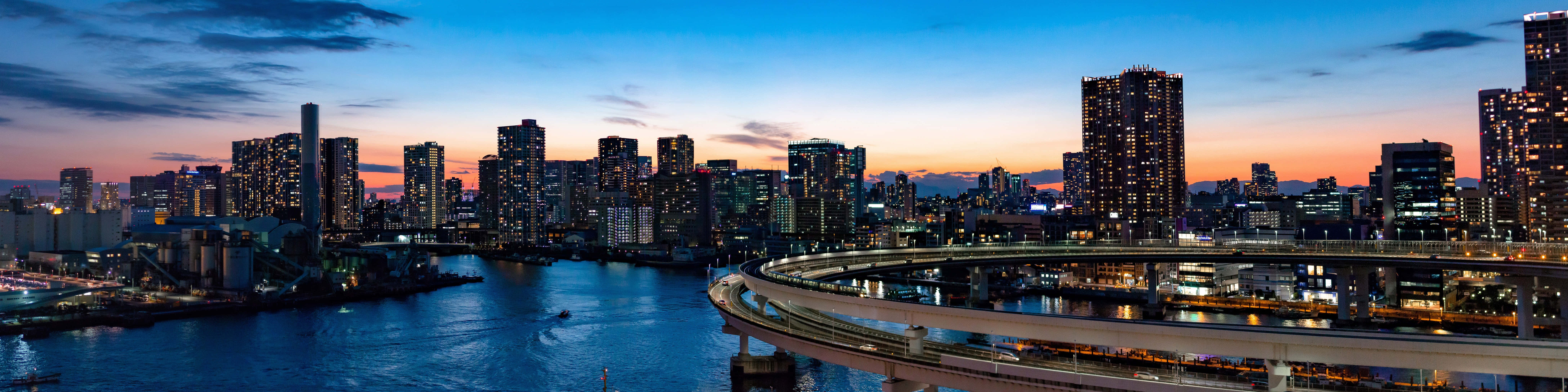A Cityscape With Bridges And Buildings At Dusk Wallpaper