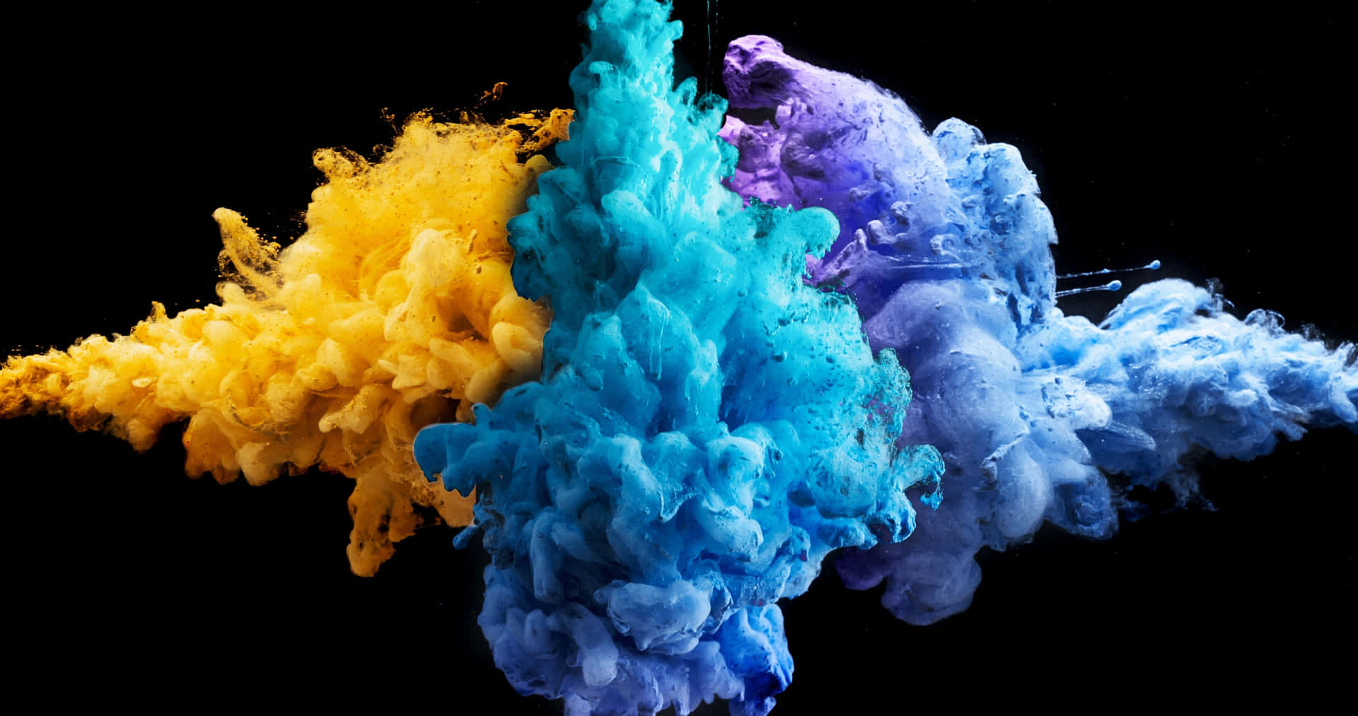 a colorful explosion of ink on a black background Wallpaper