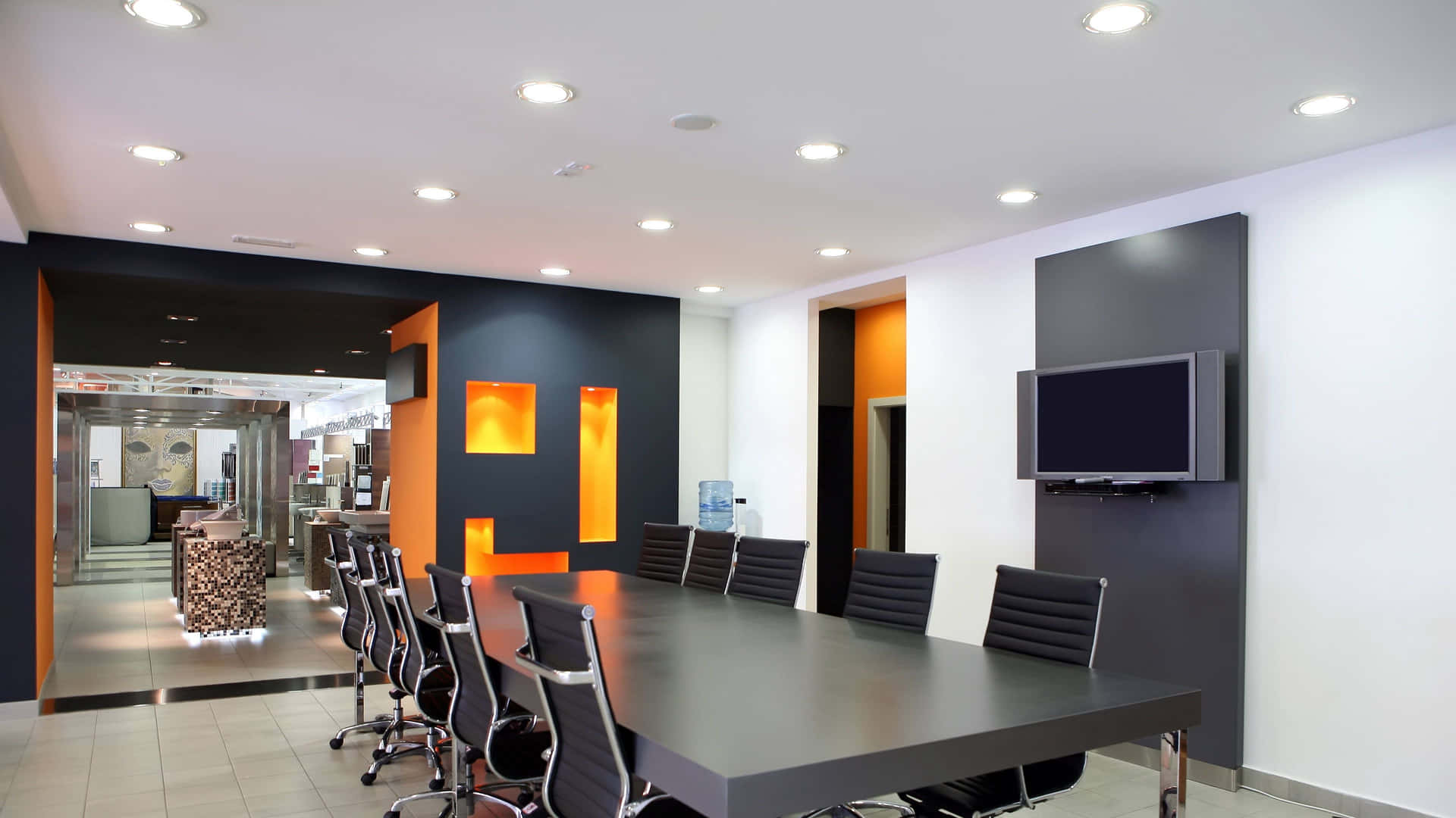 a conference room with orange walls and black chairs