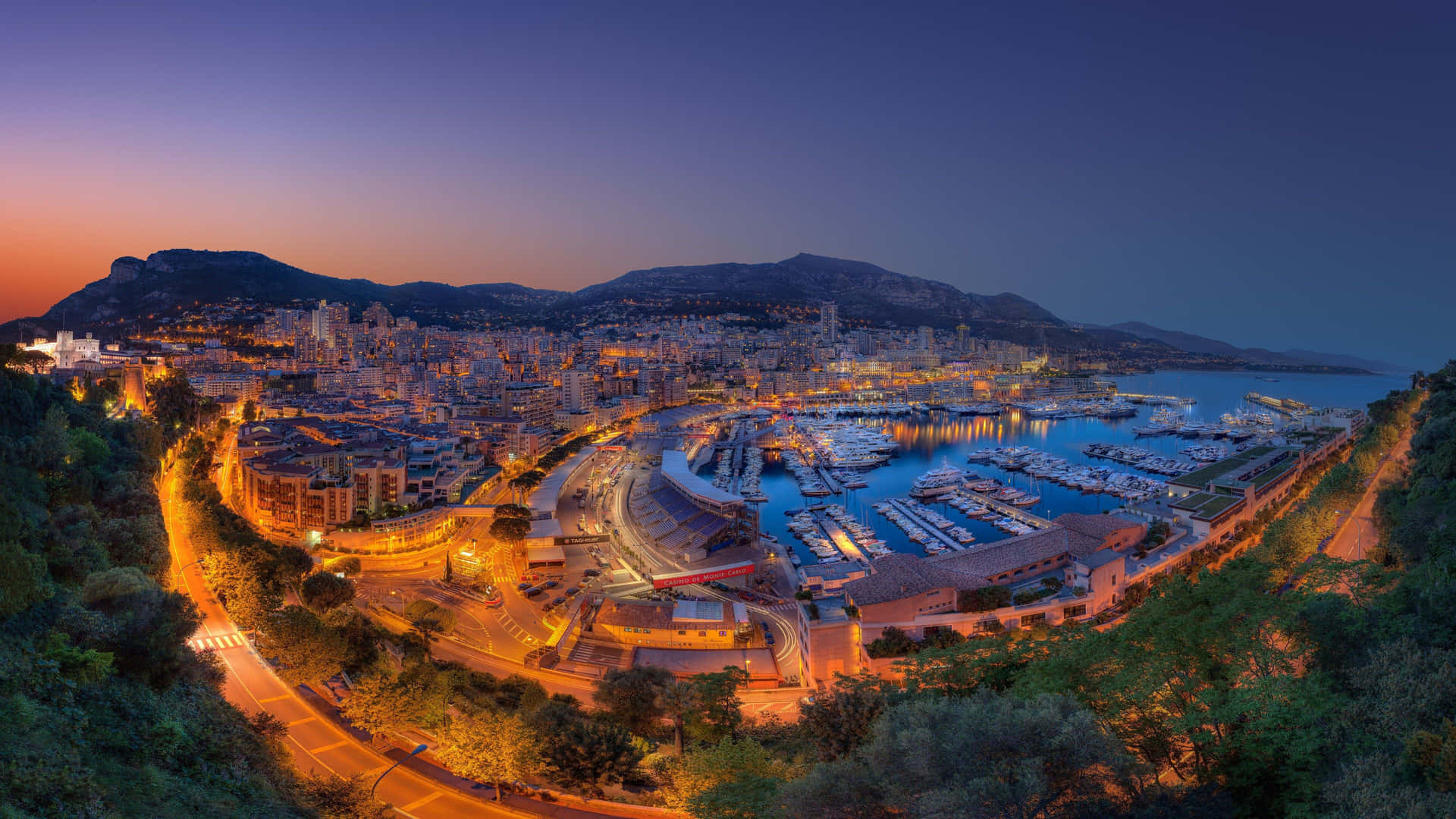 A View Of The City Of Monaco At Night