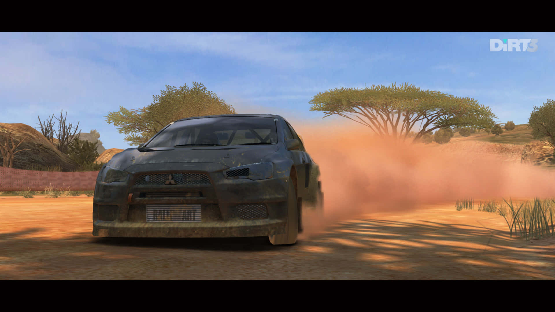 A Car Driving Through A Dirt Road