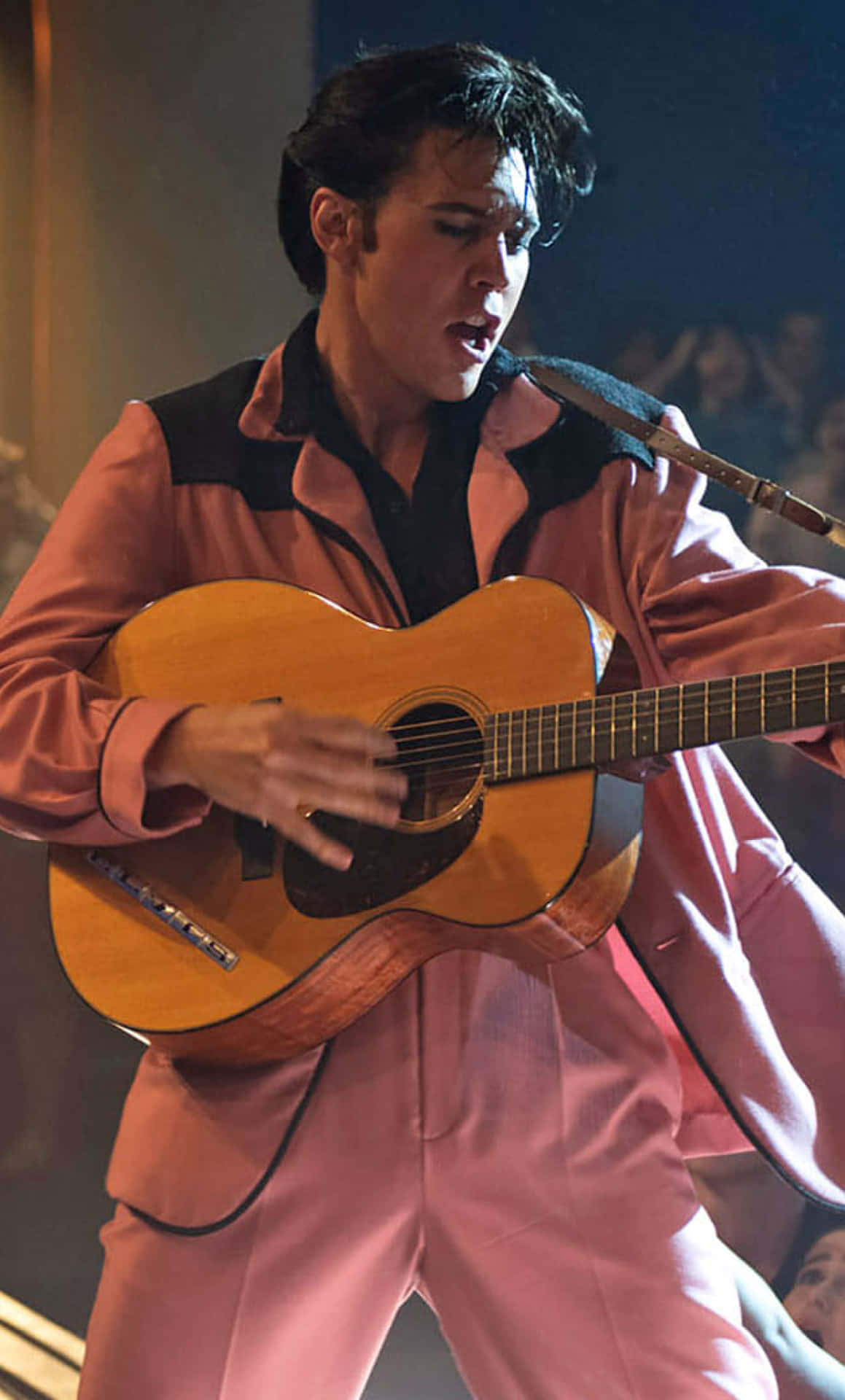 Elvis Presley In Pink Suit Playing Guitar Wallpaper