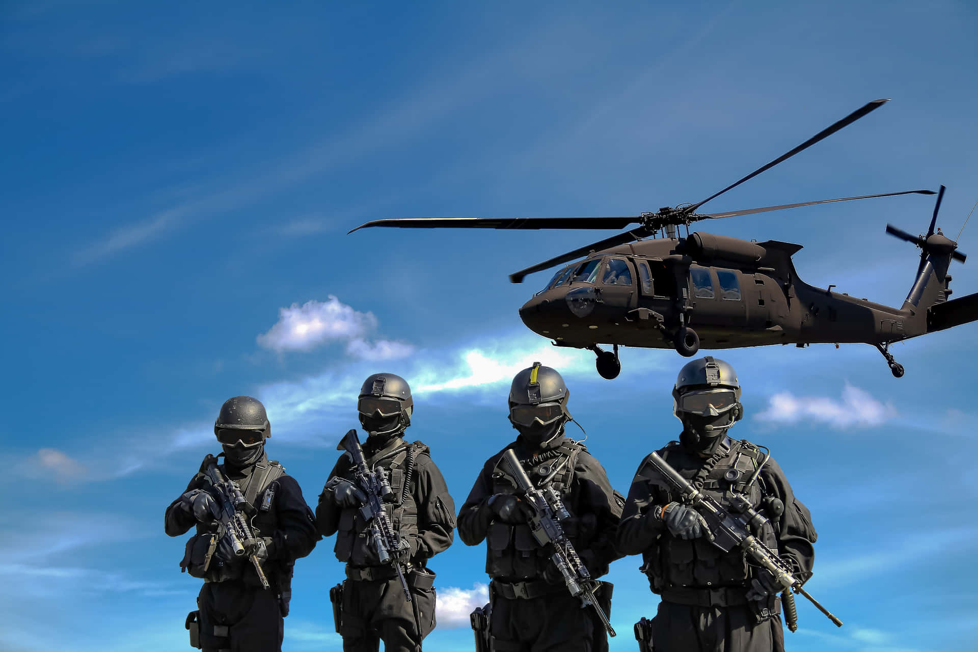 A Group Of Soldiers Standing In Front Of A Helicopter