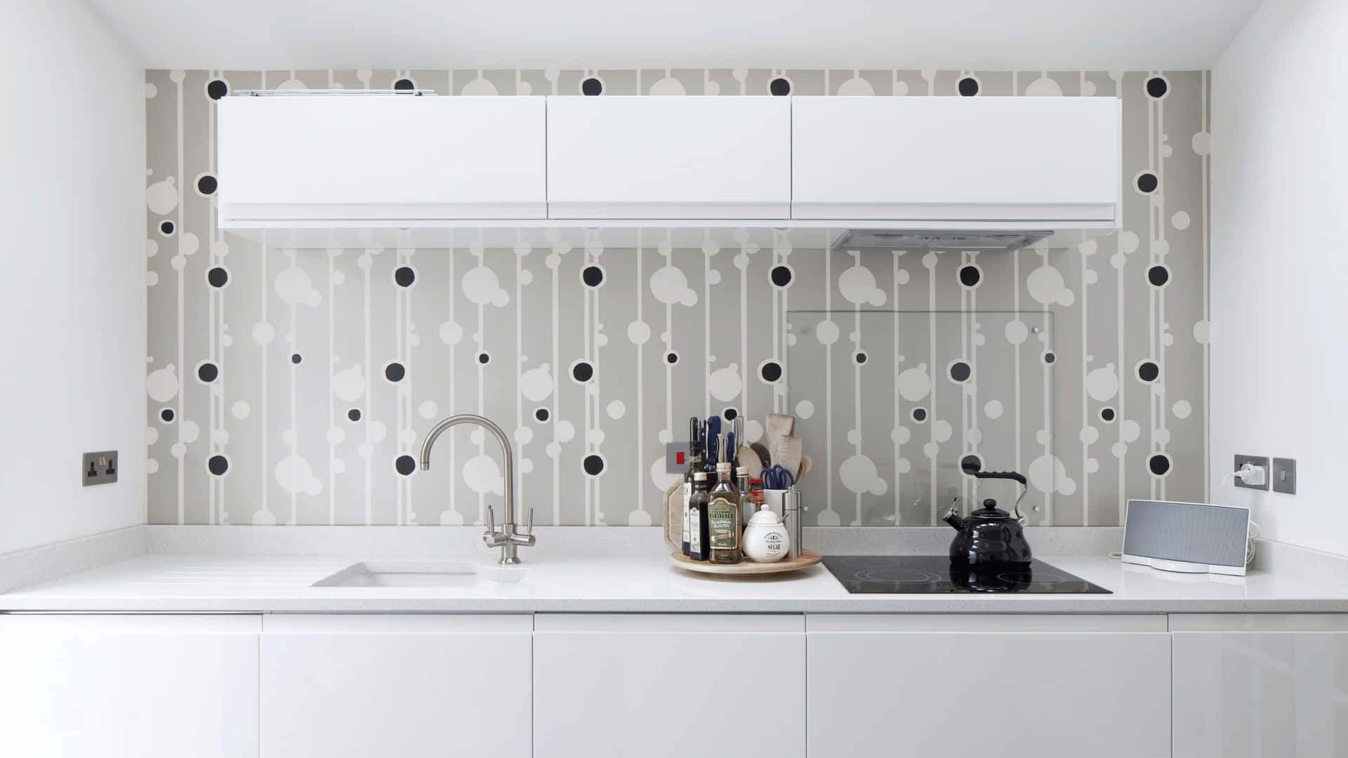 A White Kitchen With A Black And White Wallpaper