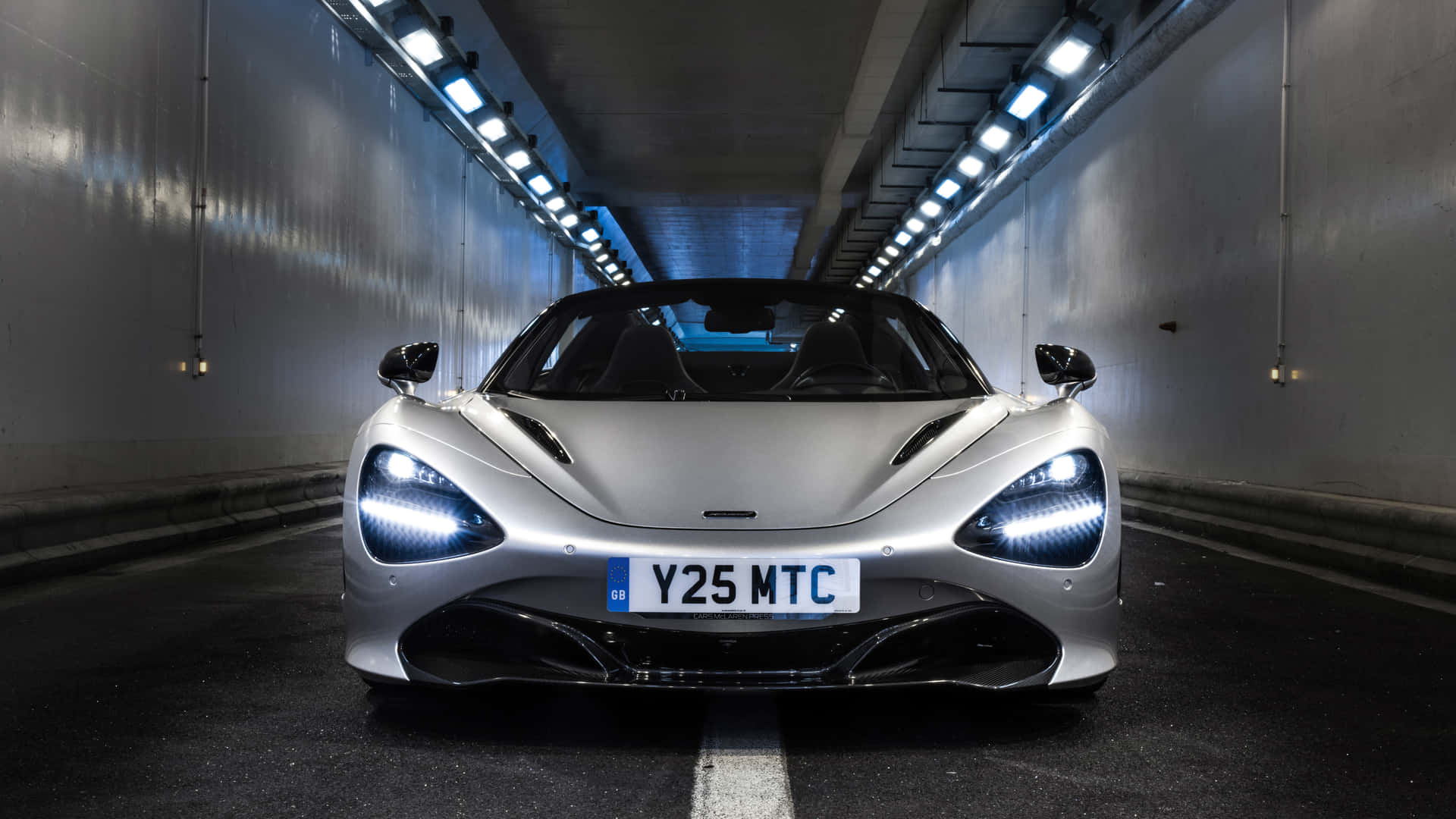 A Silver Sports Car Is Parked In A Tunnel