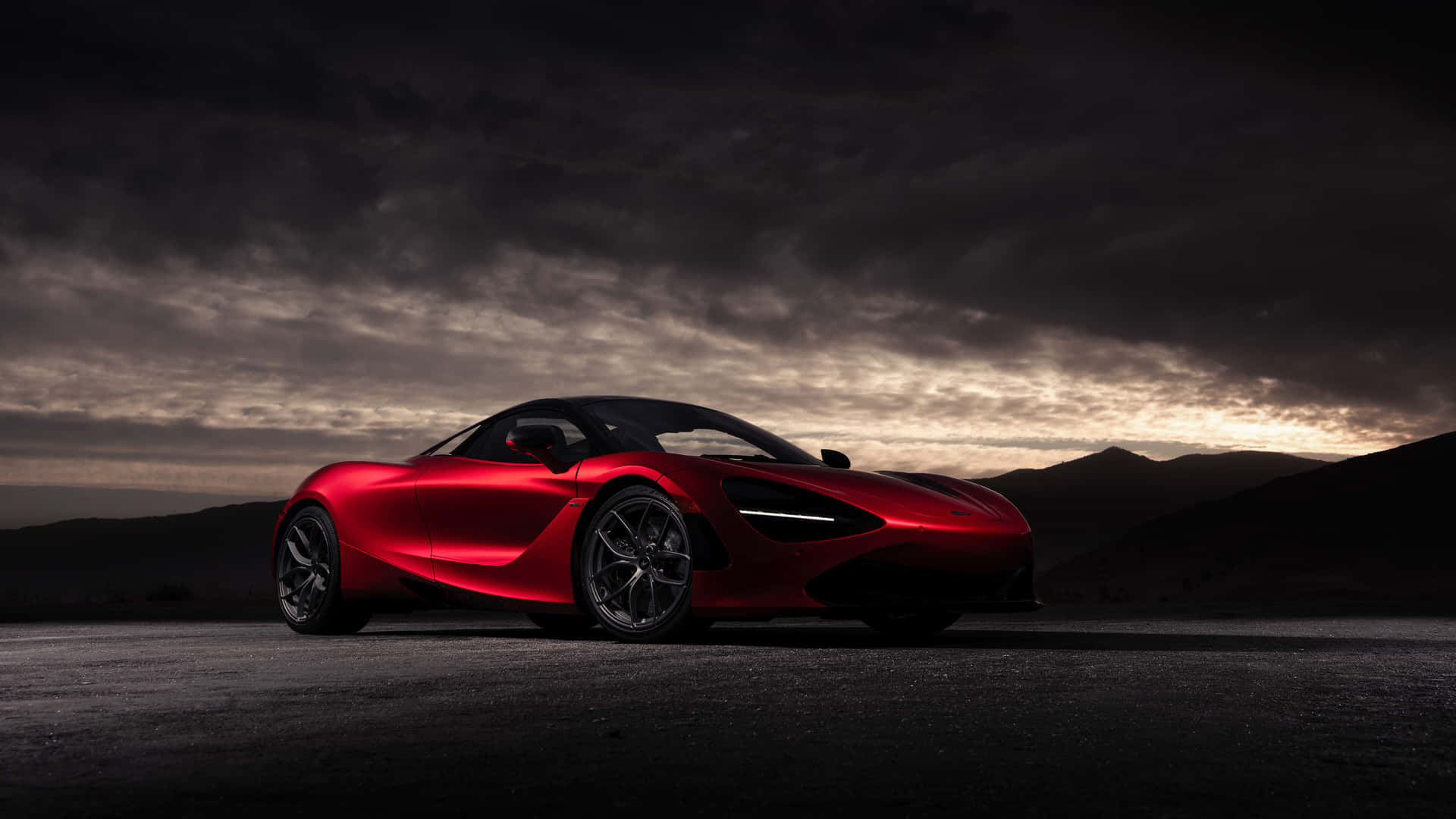 A Red Sports Car Is Parked In The Desert