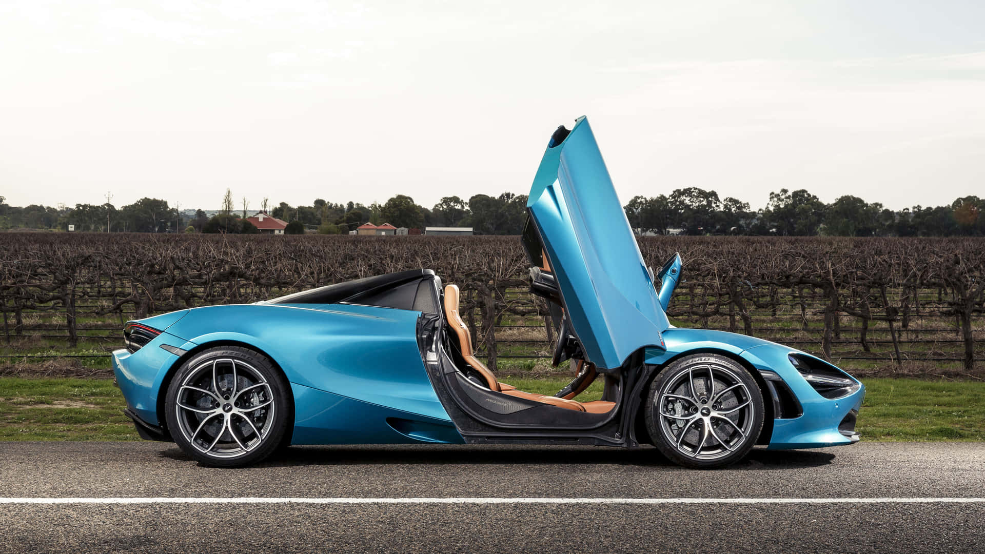 A Blue Sports Car With Its Doors Open
