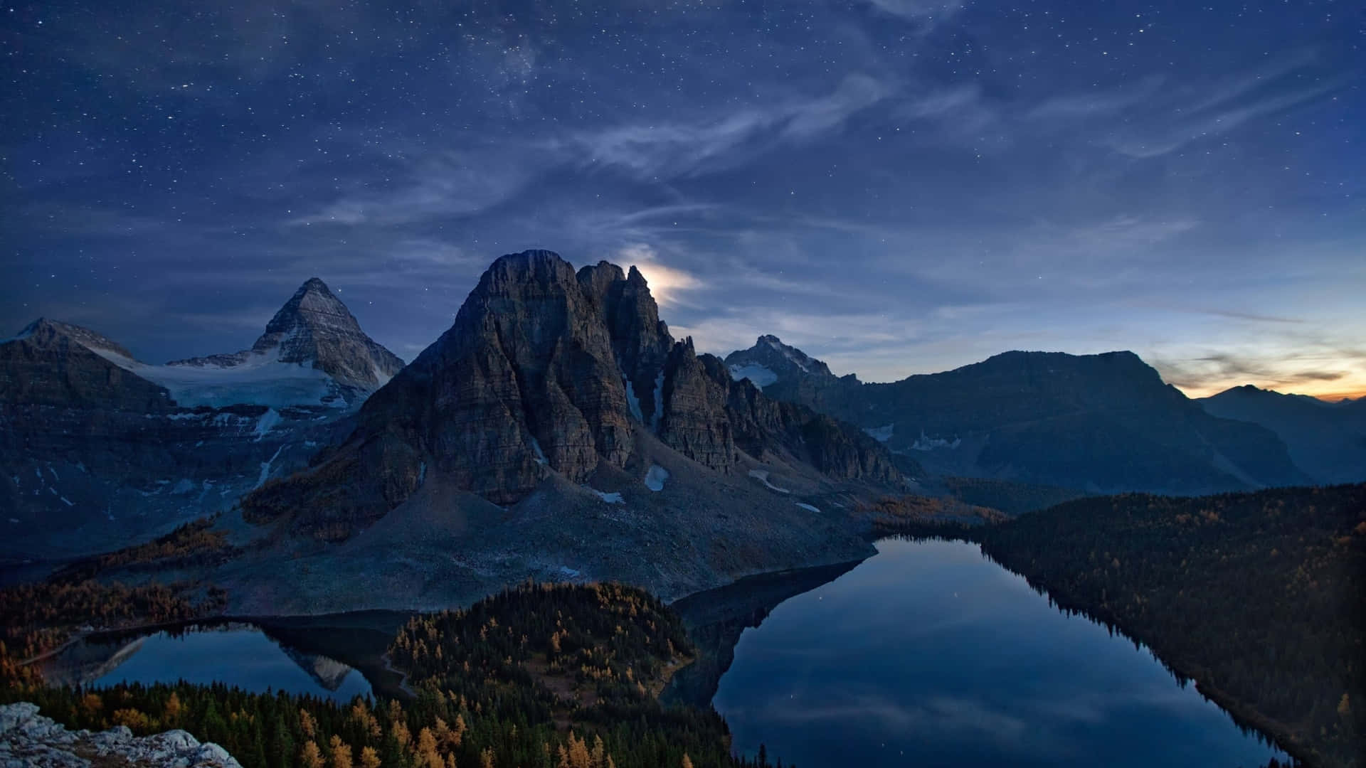 An awe-inspiring view of a snow-capped mountain range Wallpaper