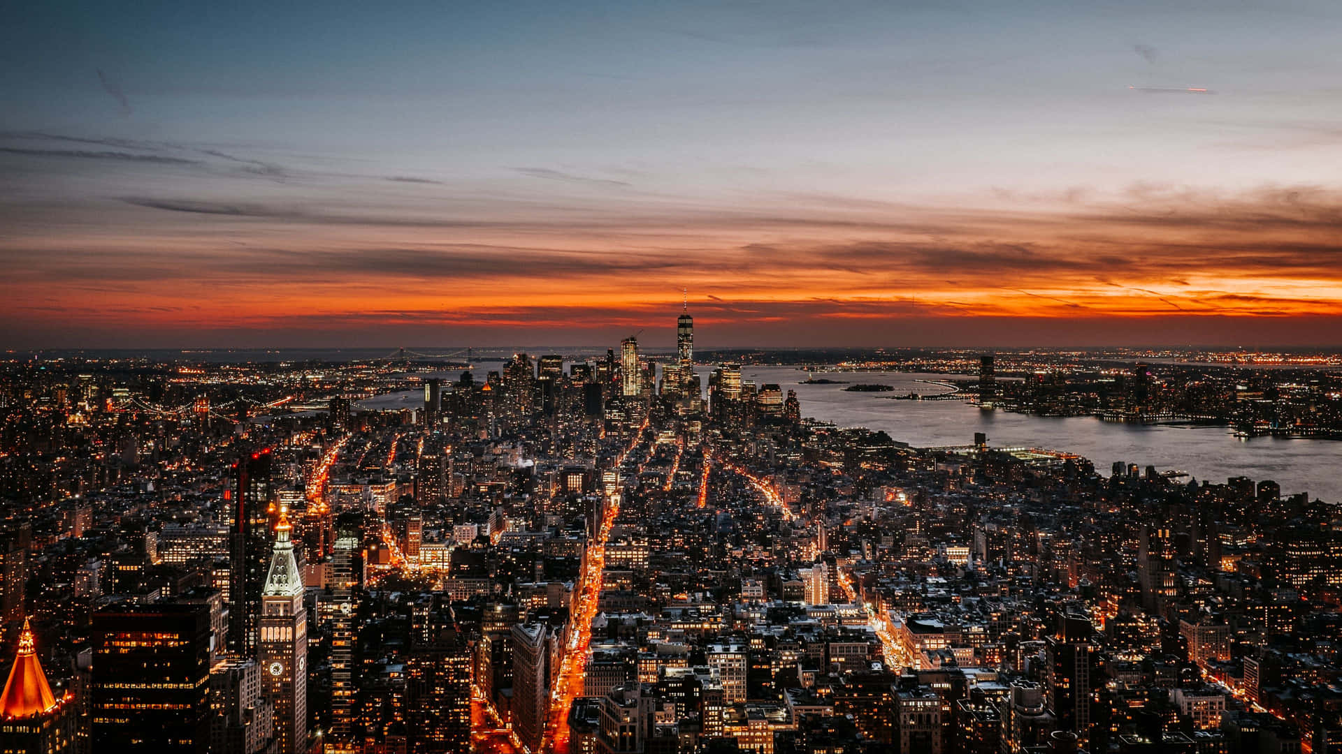 Enjoy the bustling beauty of NYC at night Wallpaper