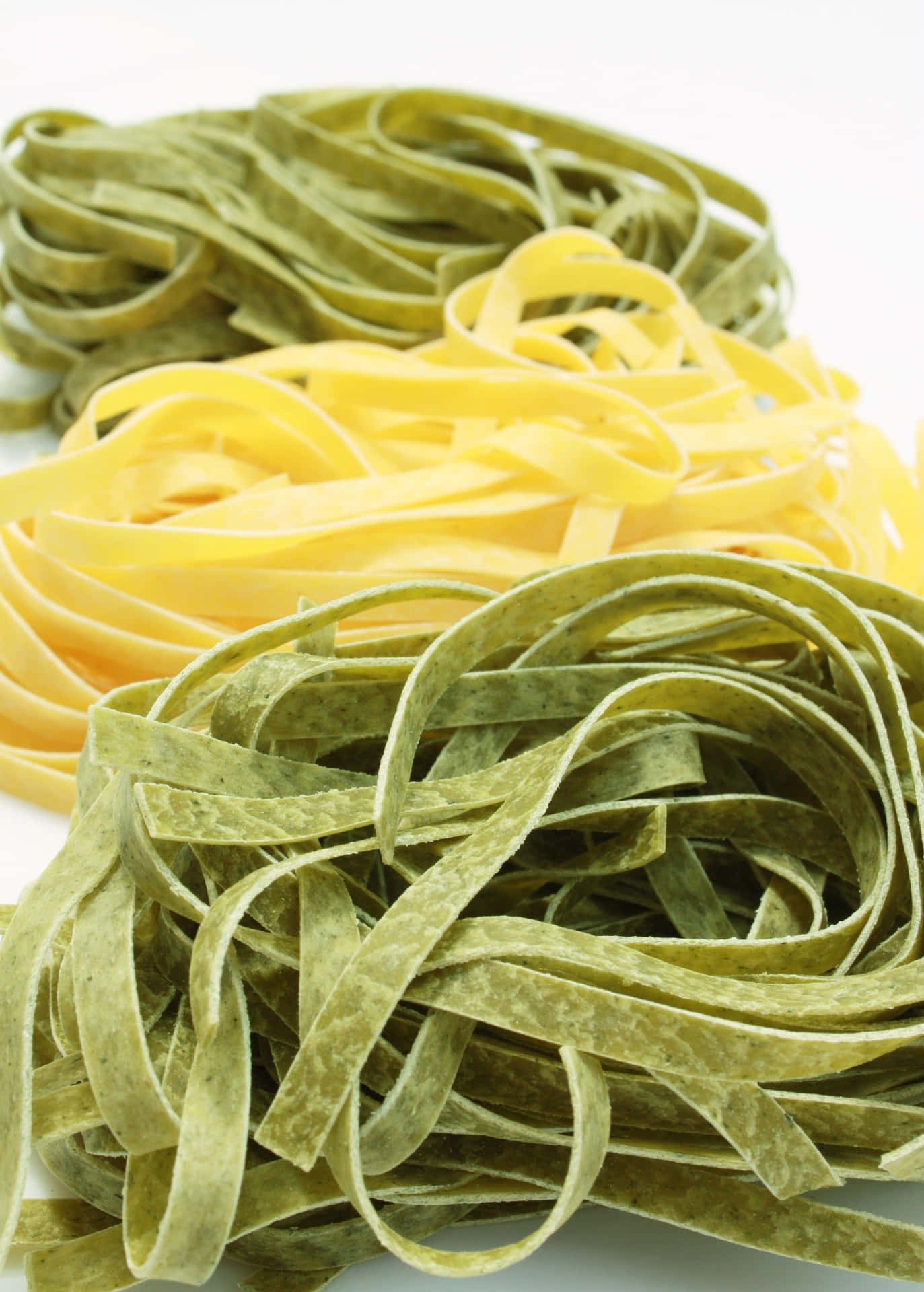A Pile Of Green And Yellow Pasta