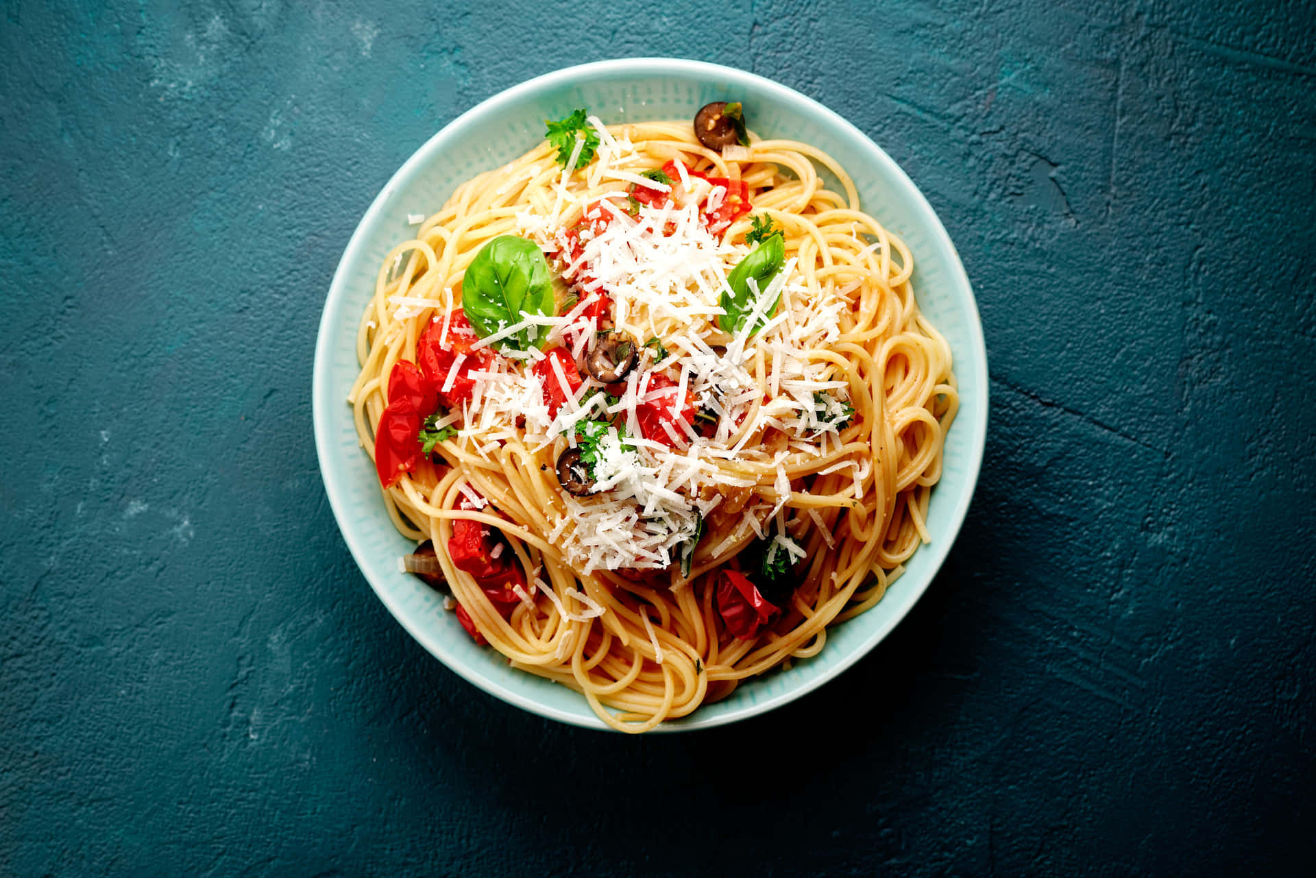 Spaghetti With Peppers And Parmesan On A Blue Background