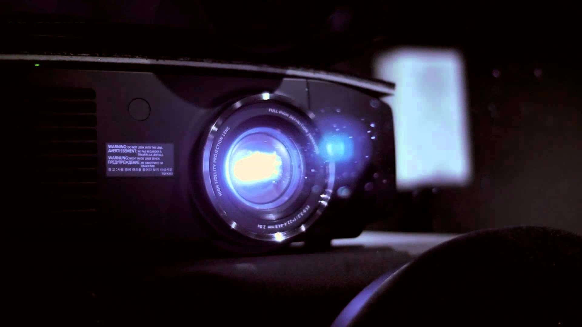 A 4K projector displaying crystal-clear image on a screen Wallpaper