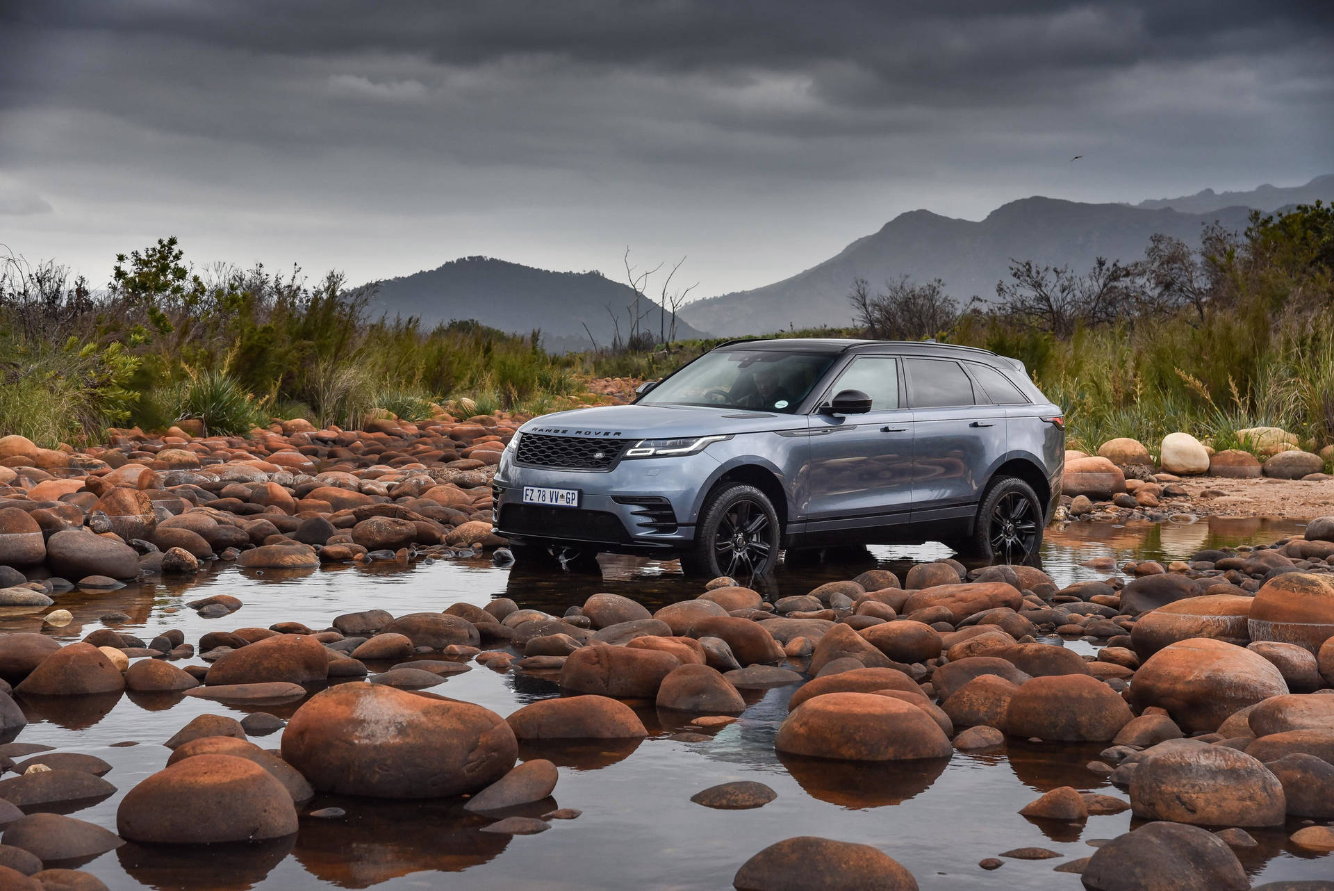 Majestic 4k Range Rover Velar Amidst Nature's Stones Wallpaper