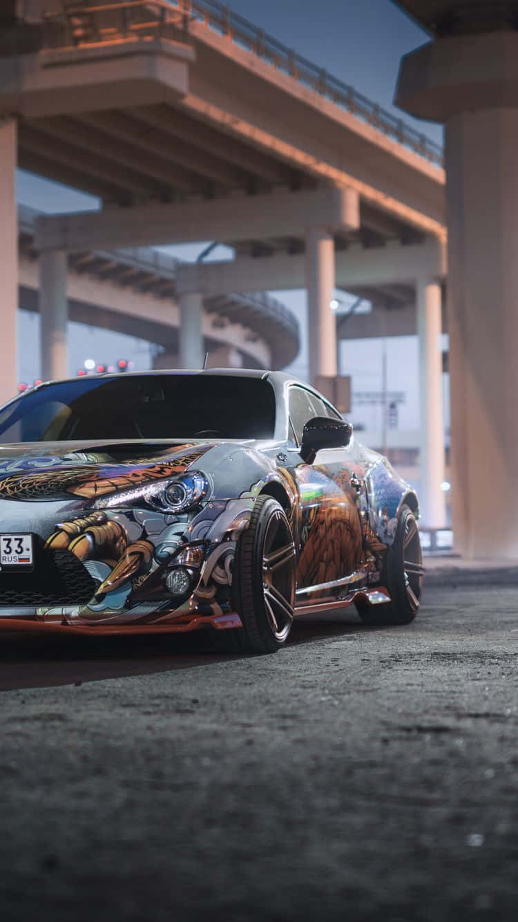 A Toyota 86 Parked On A Street With A Graffiti On It Wallpaper
