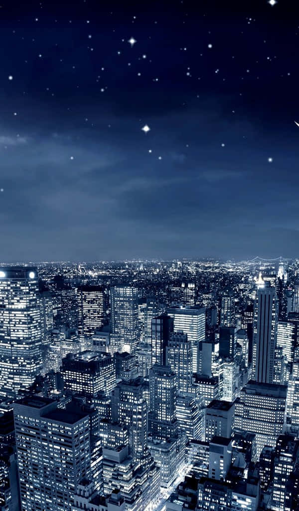 a city at night with stars and clouds Wallpaper